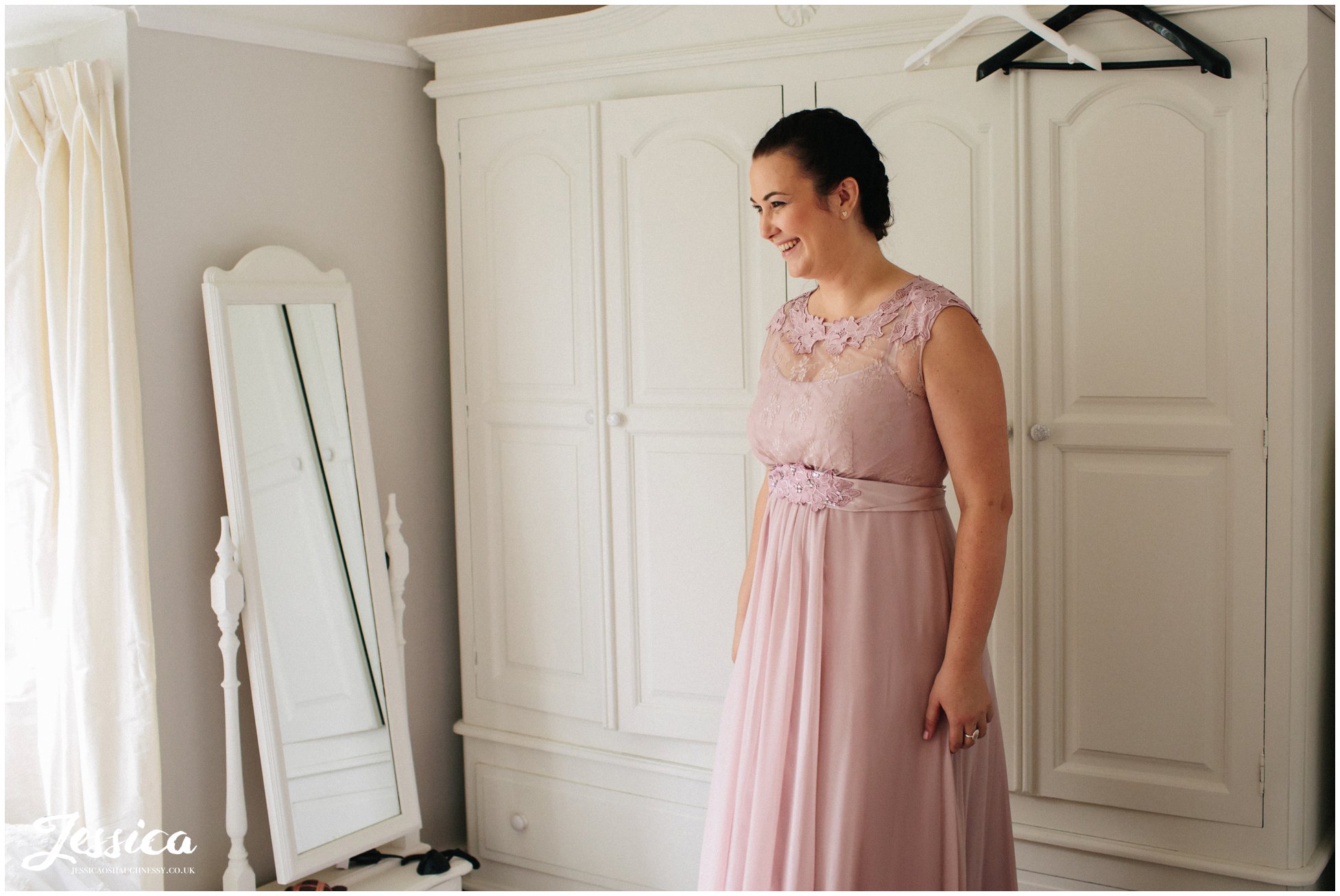 bridesmaid admire bride at her wedding in farndon, chester