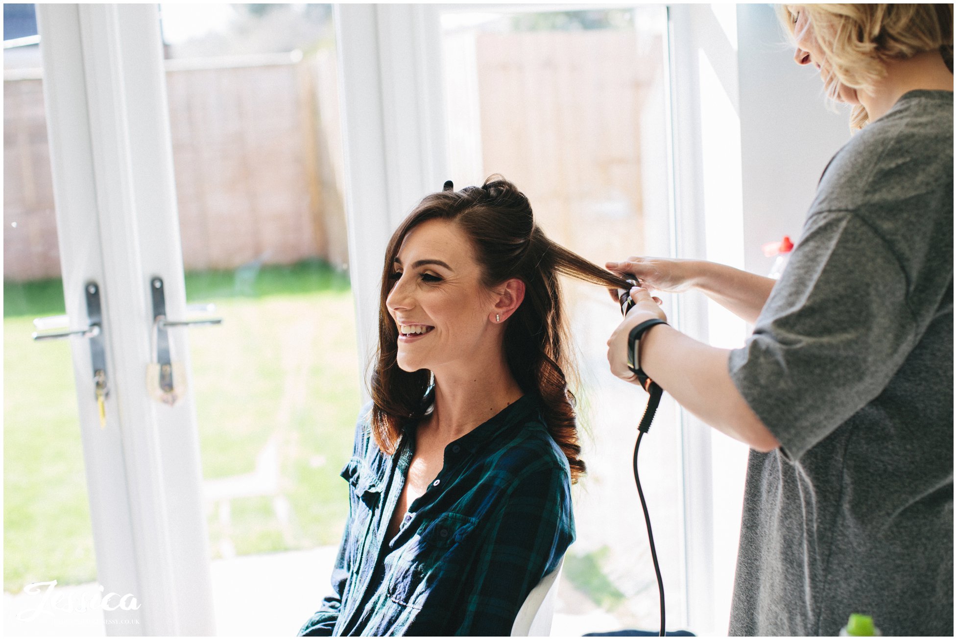 bride has her hair curled ready for her wedding day