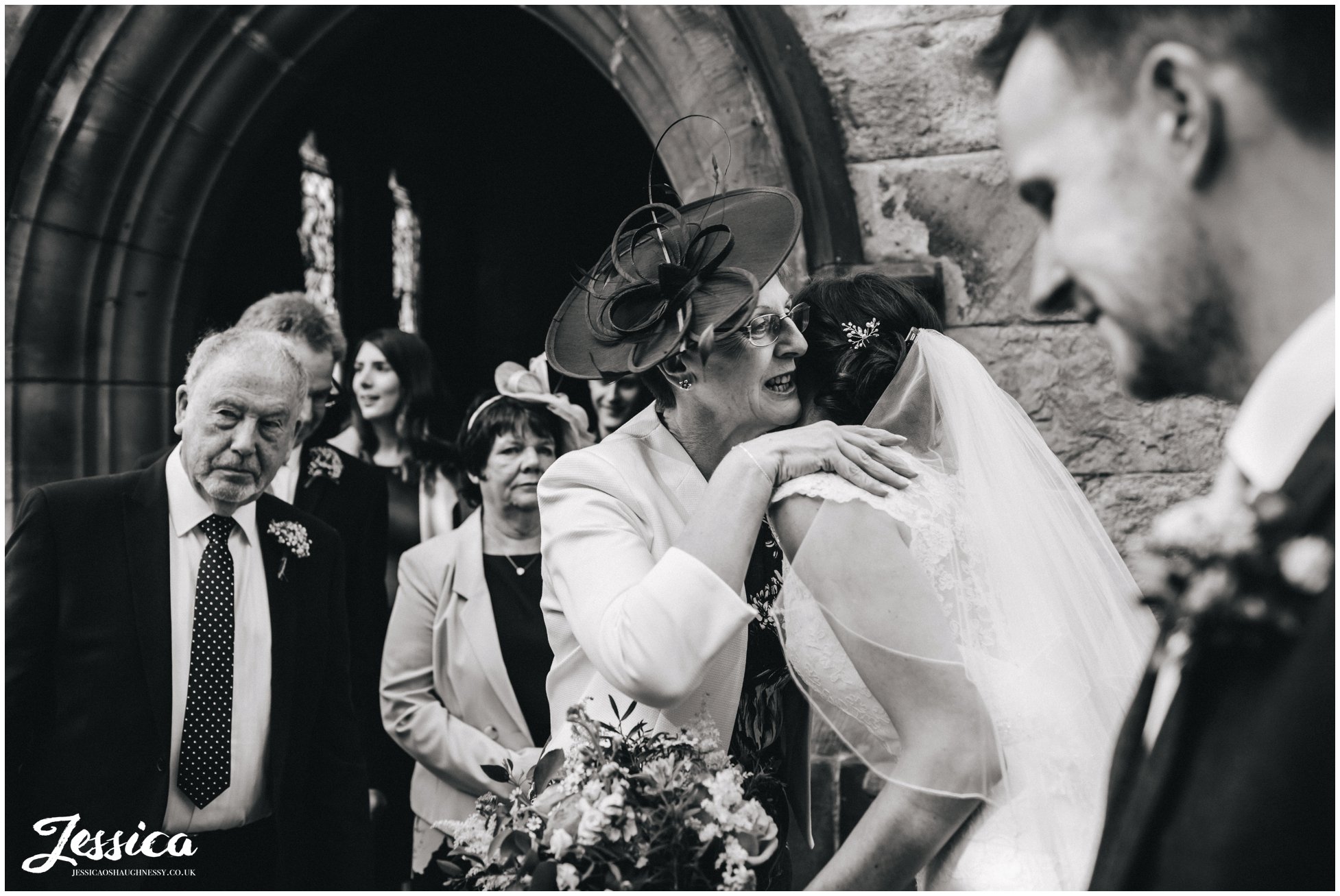 mother of the bride hugs her daughter after her wedding ceremony in north wales