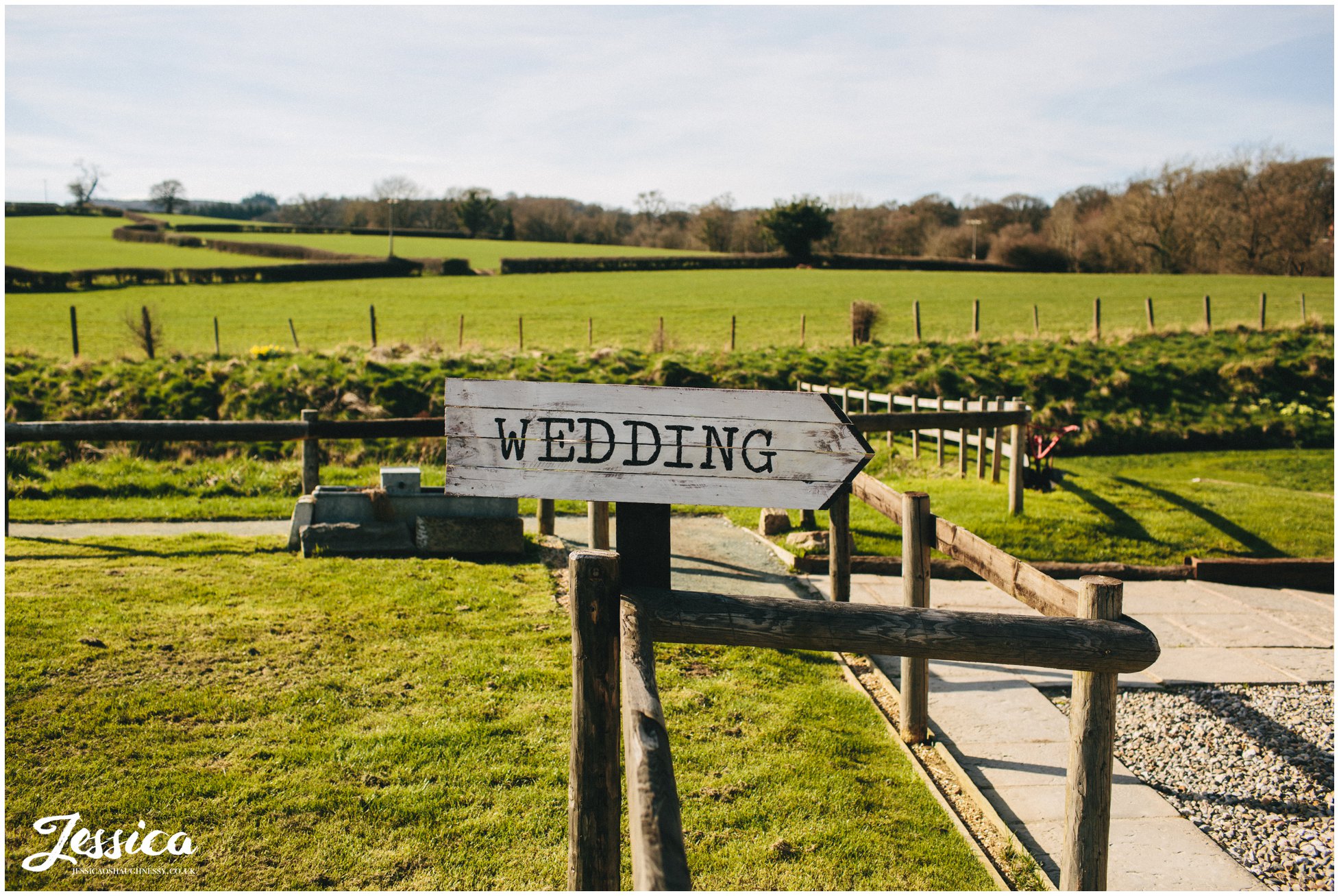 sign pointing wedding guests to the reception at tower hill barns