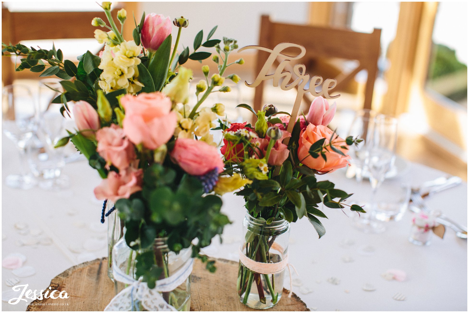 rustic flowers decorate each table at tower hill barns - north wales