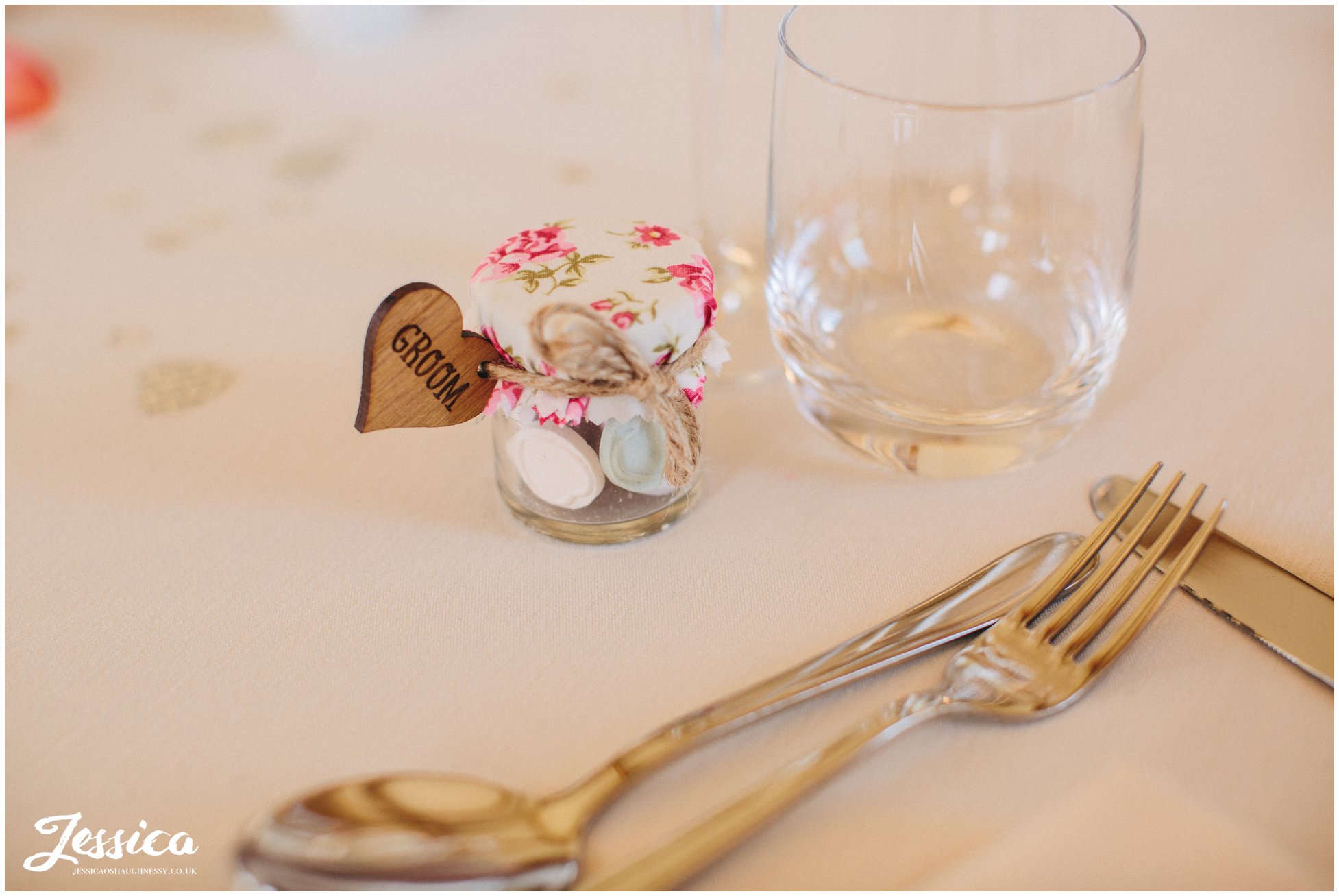 close up of groom's wooden heart place name at a north wales wedding