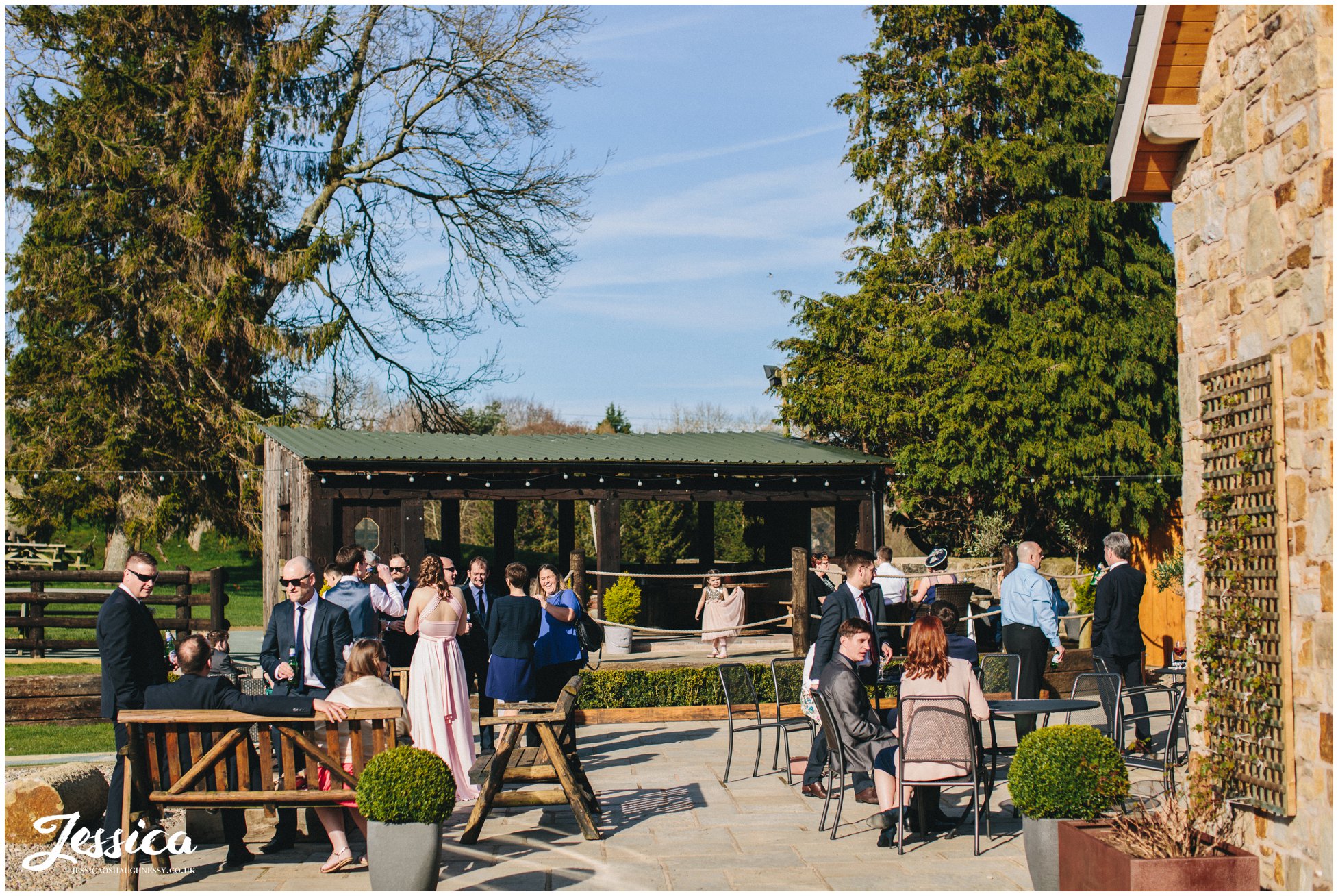 guests stood in the sunshine at the wedding reception in north wales