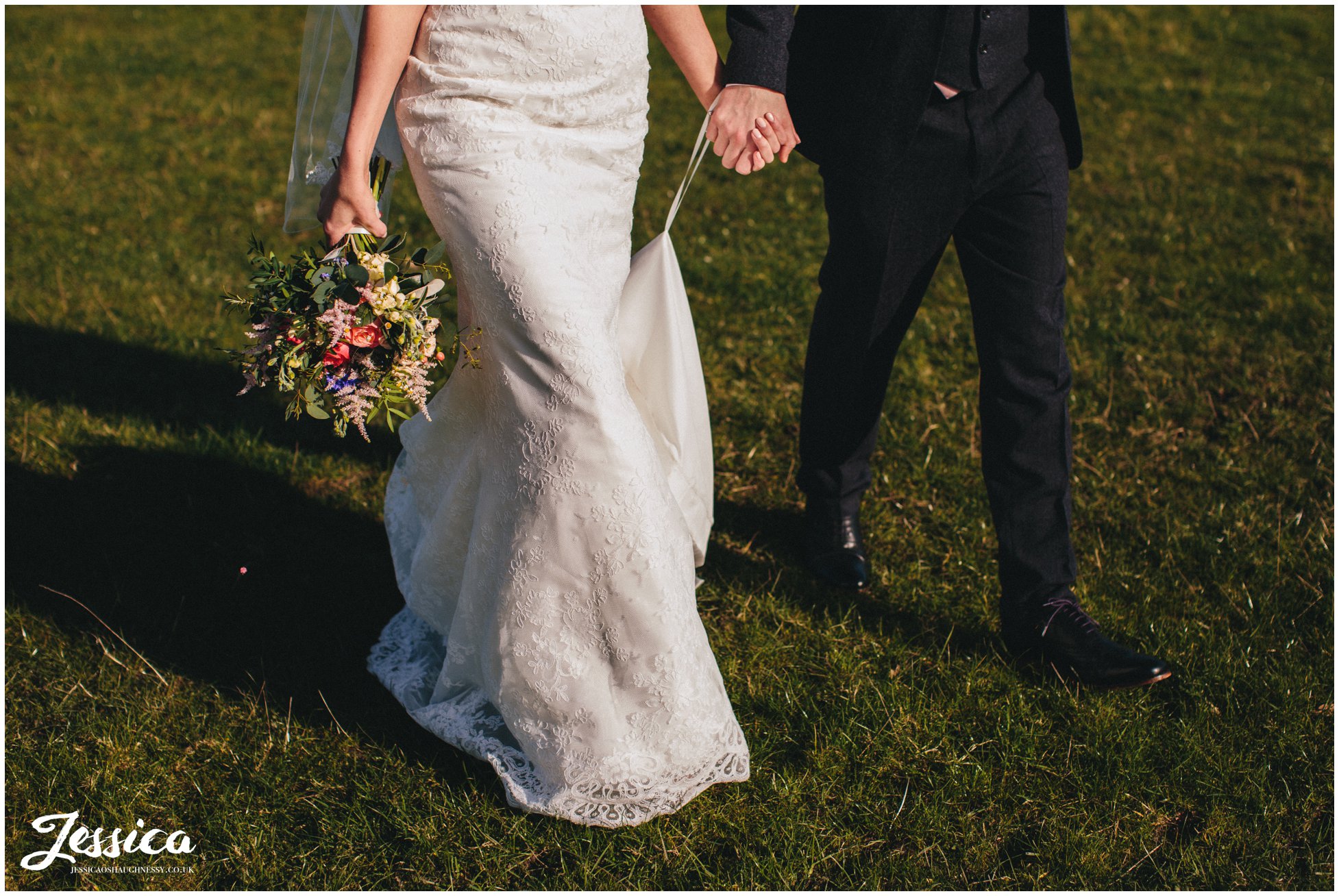 cropped image of bride and groom walking