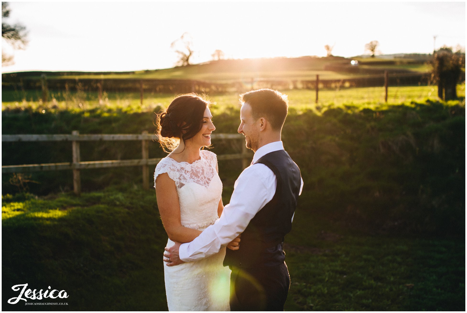 bride & groom laugh in the sunlight on the evening of their wedding day in north wales