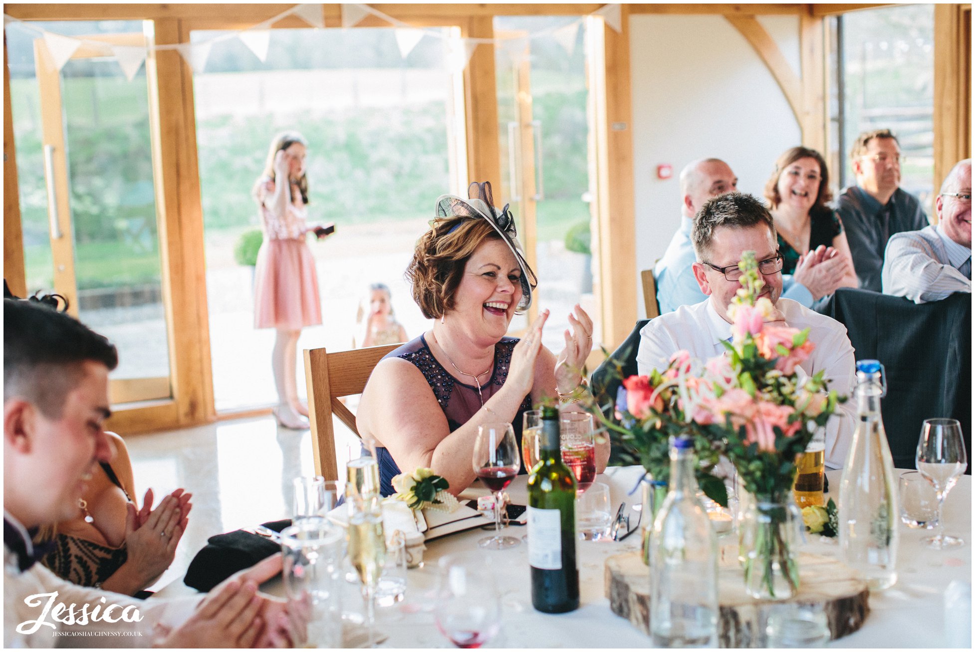 guests laugh as the groom gives his speech on his wedding day in north wales