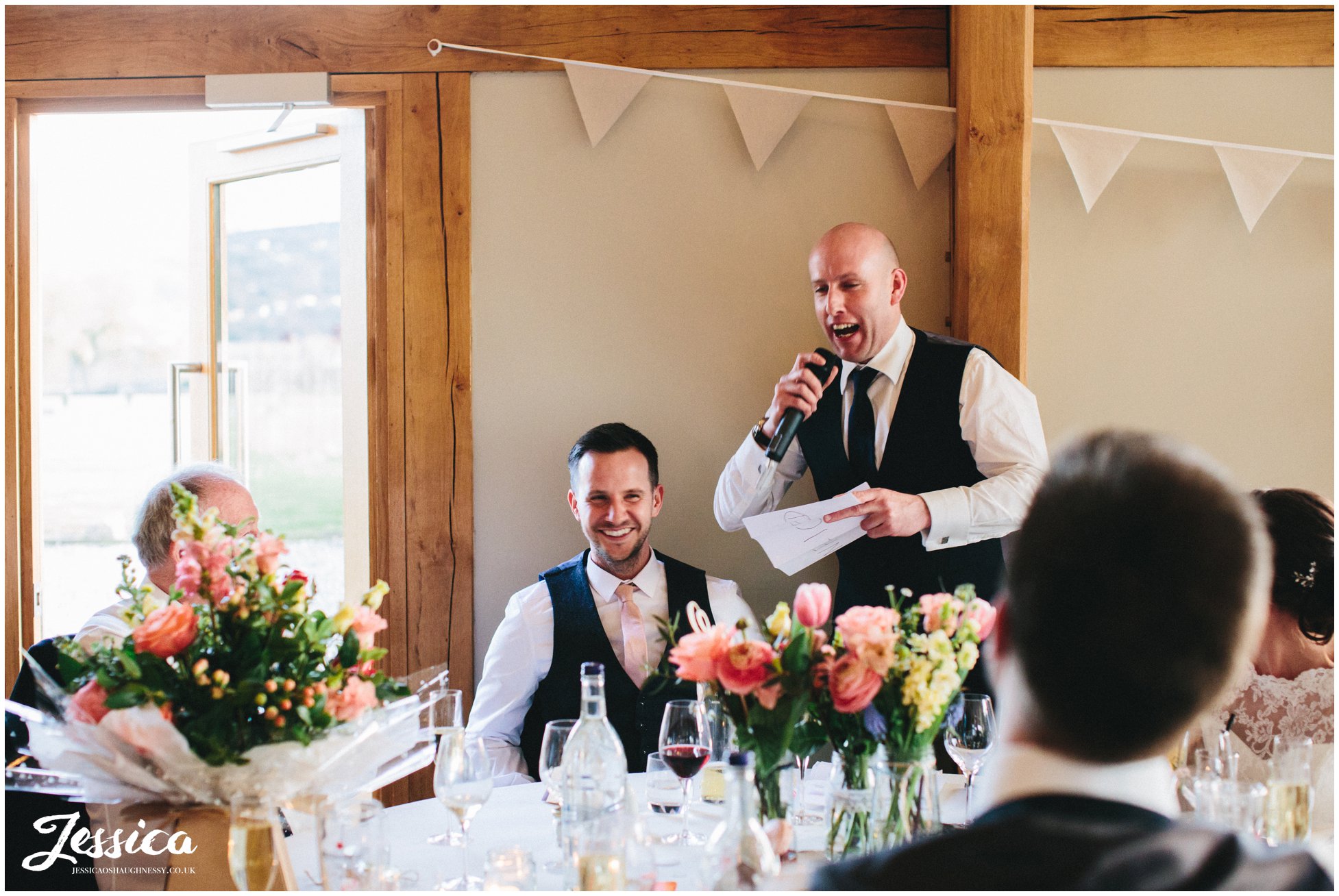 groom laughs during his best mans speech at tower hill barns wedding