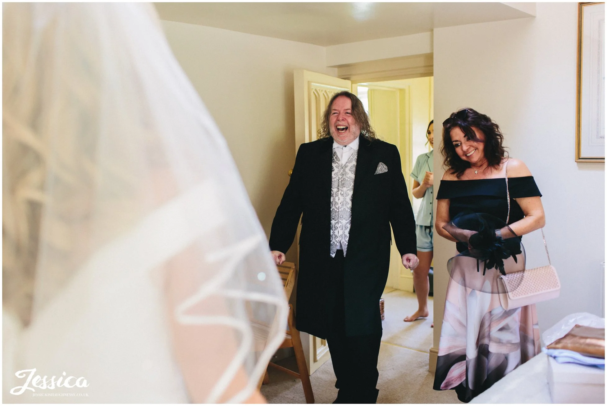 parents of the bride see their daughter in her wedding dress at Combermere Abbey