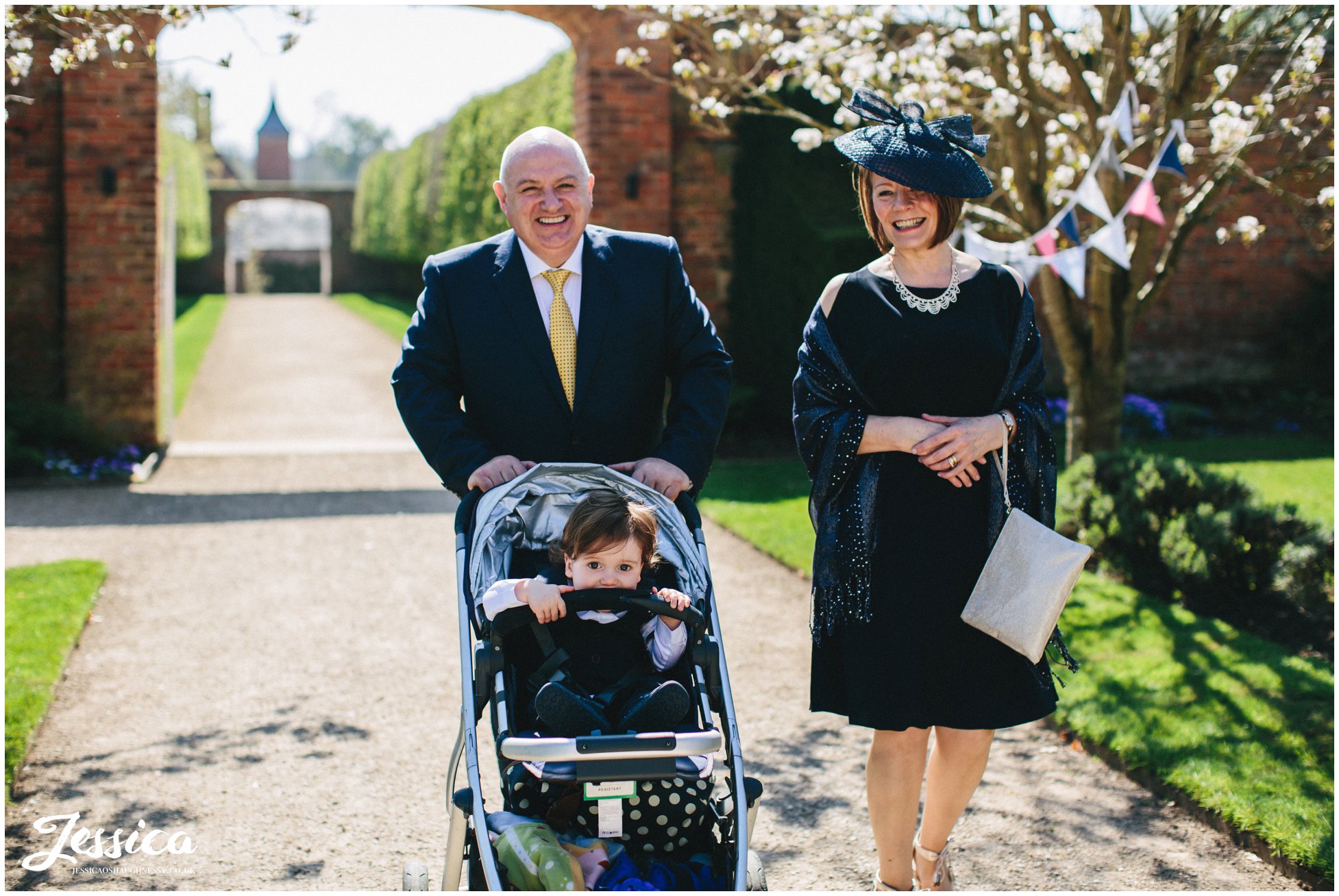grooms parents head into the ceremony at Combermere Abbey
