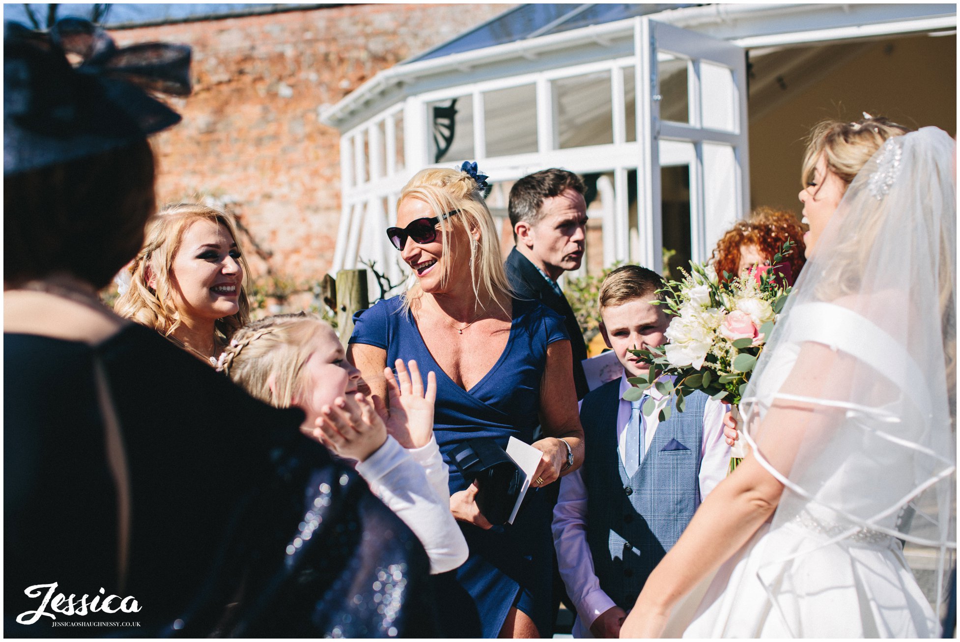 guests congratulate bride after the ceremony in shropshire
