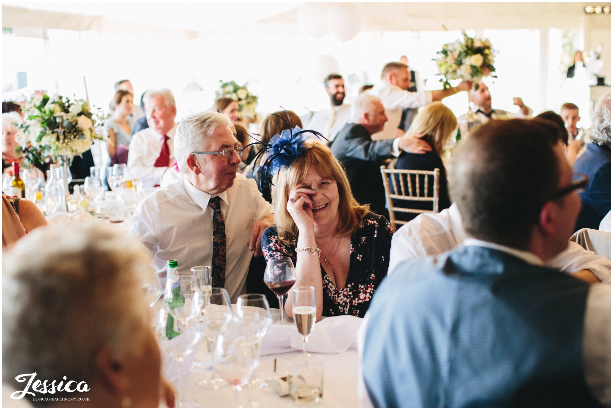 guest wipes eyes after laughing during the speeches