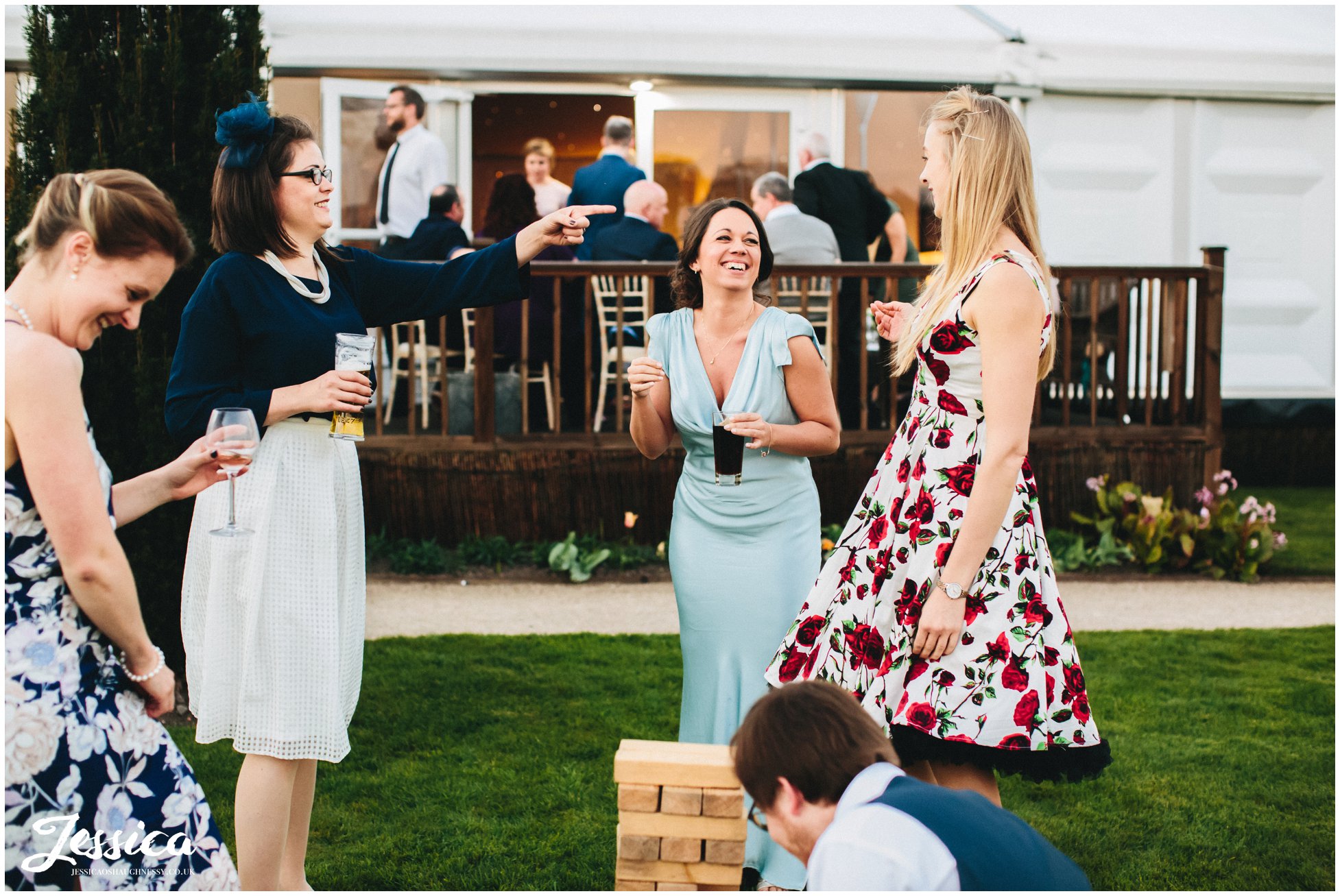 guests play lawn games at a wedding in Combermere Abbey, shropshire