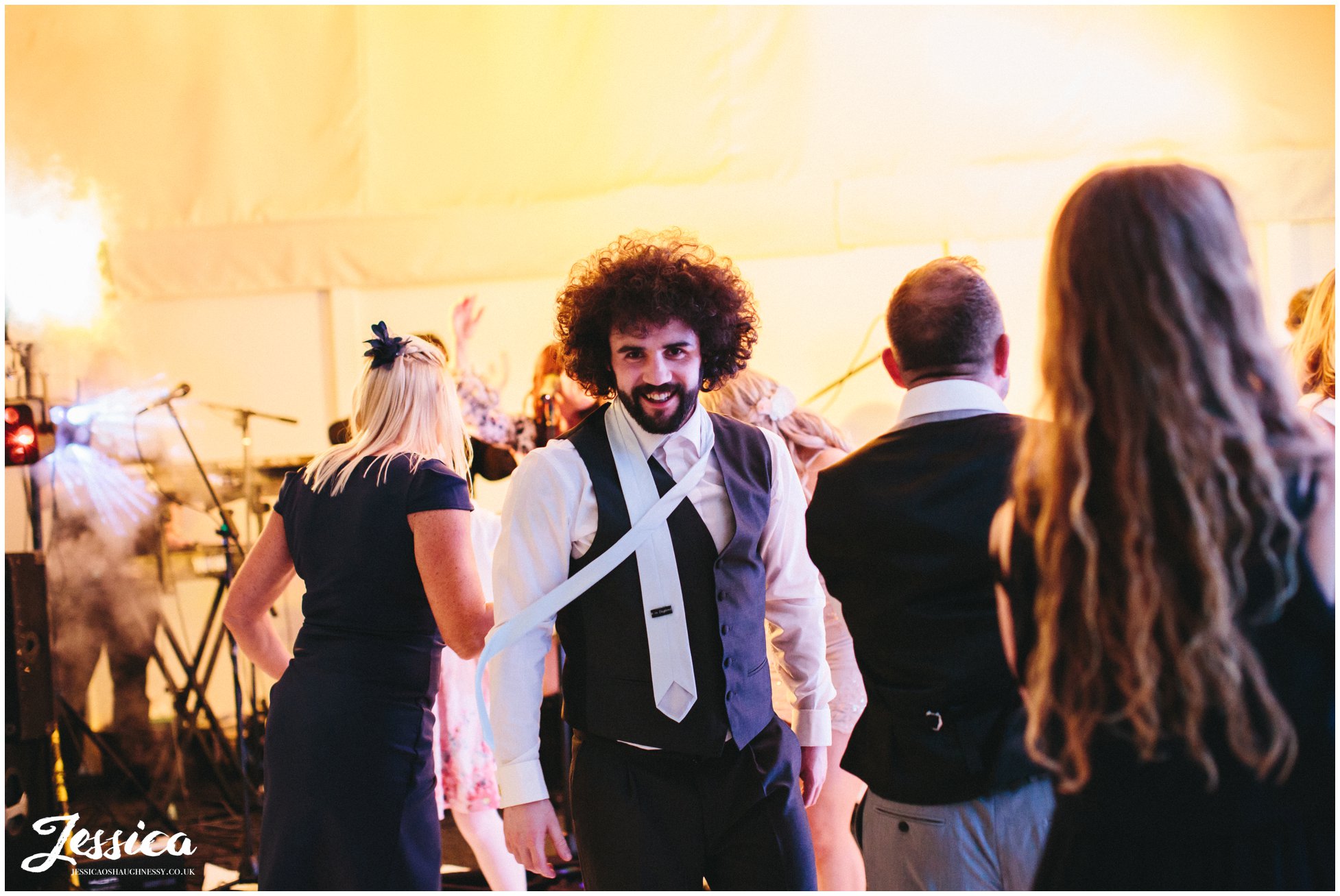 best man dances at Combermere Abbey during the wedding reception