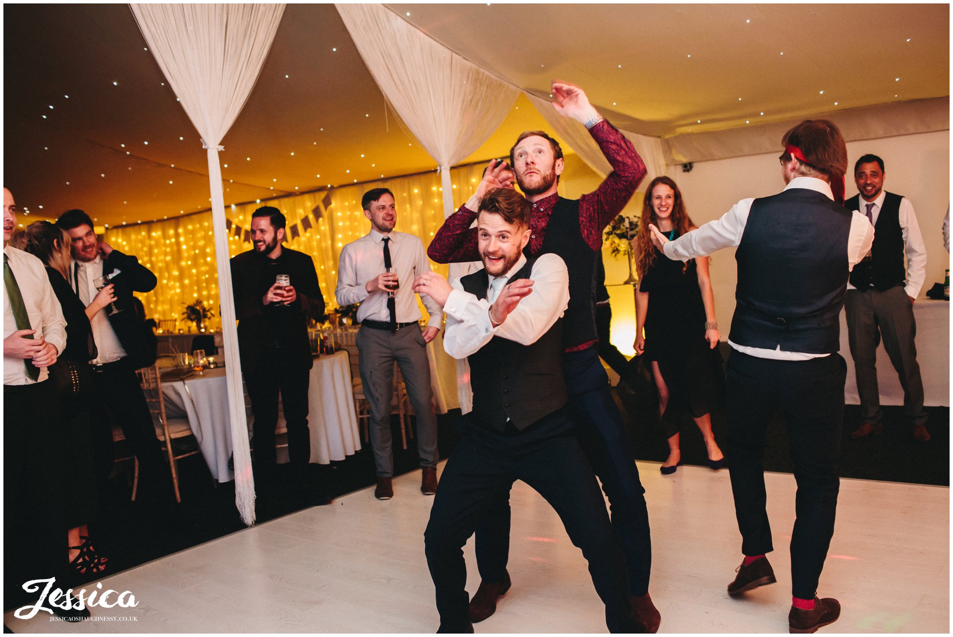 groom dances with his friend 