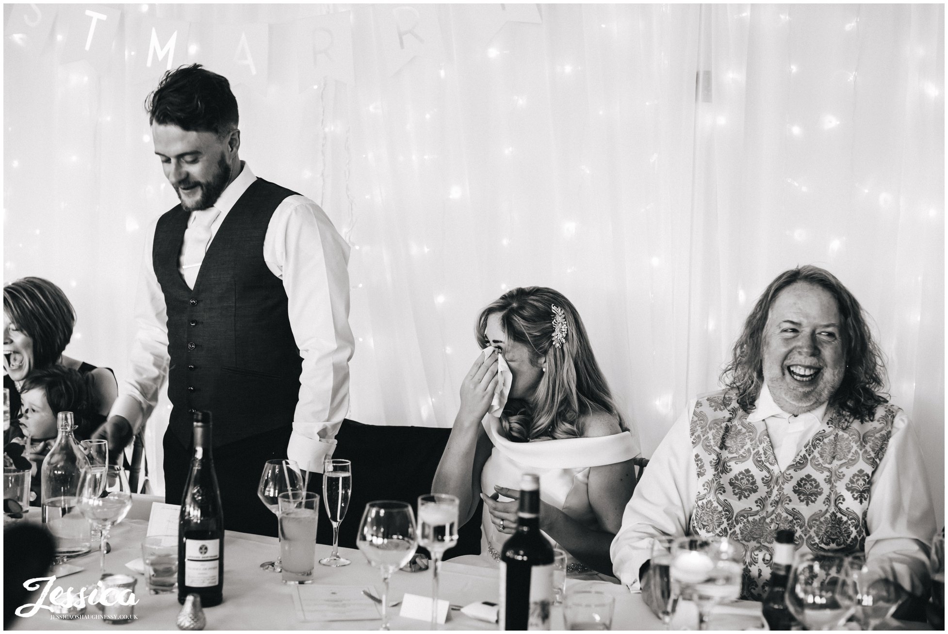 bride cries during the grooms speech on their wedding day at Combermere Abbey