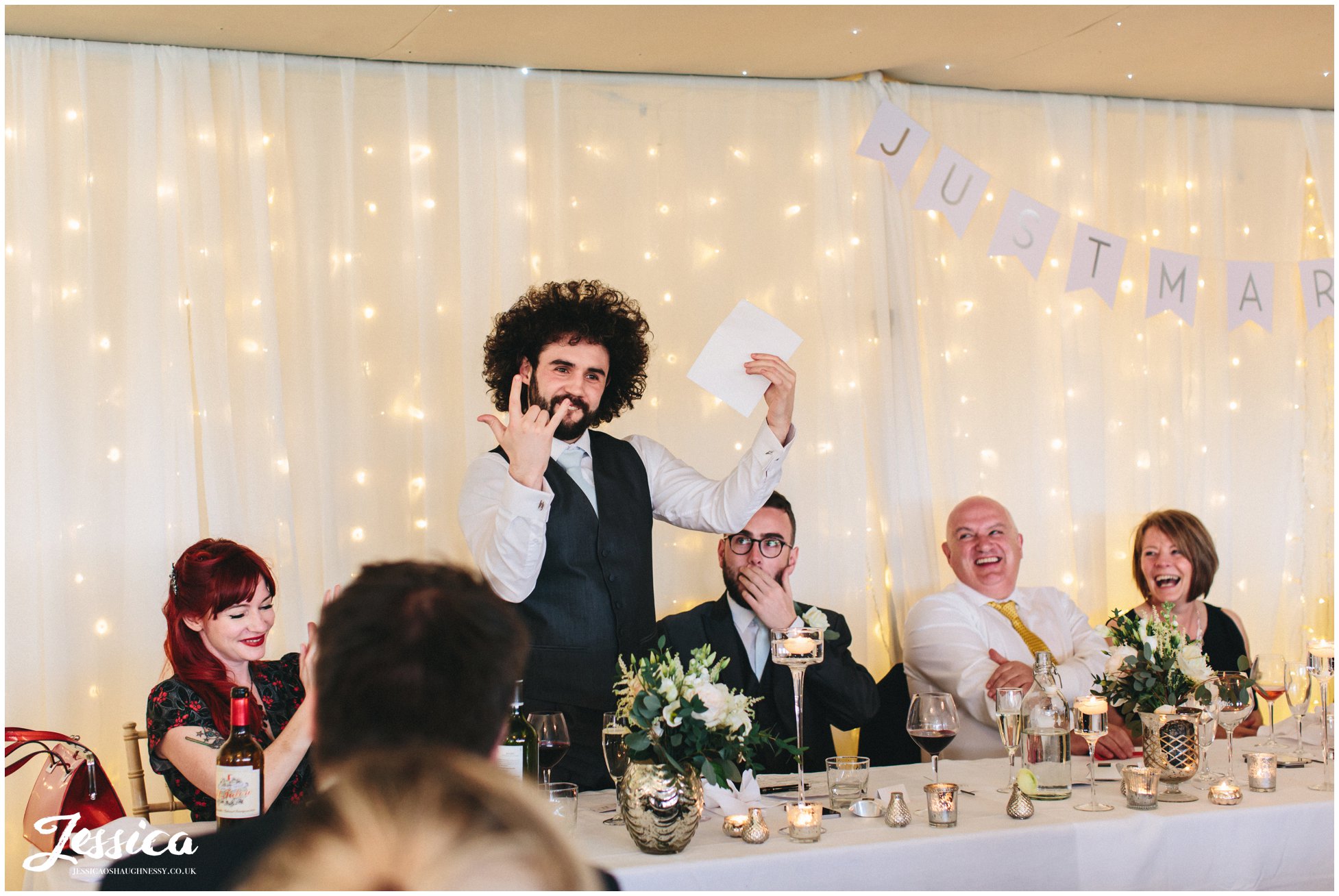 best man plays up to guests during his speech