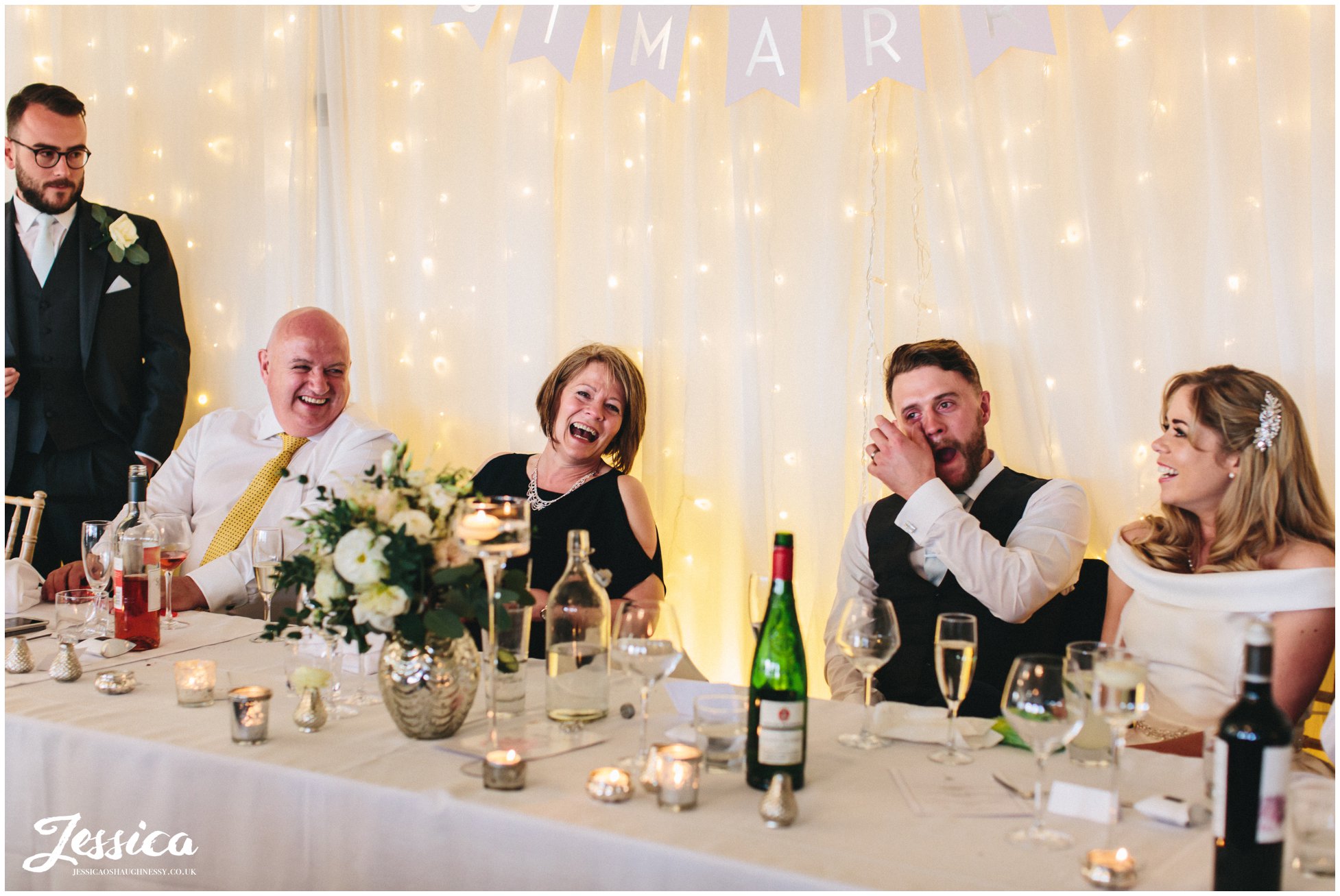 Combermere Abbey wedding photographer - top table laugh during best man's speech 