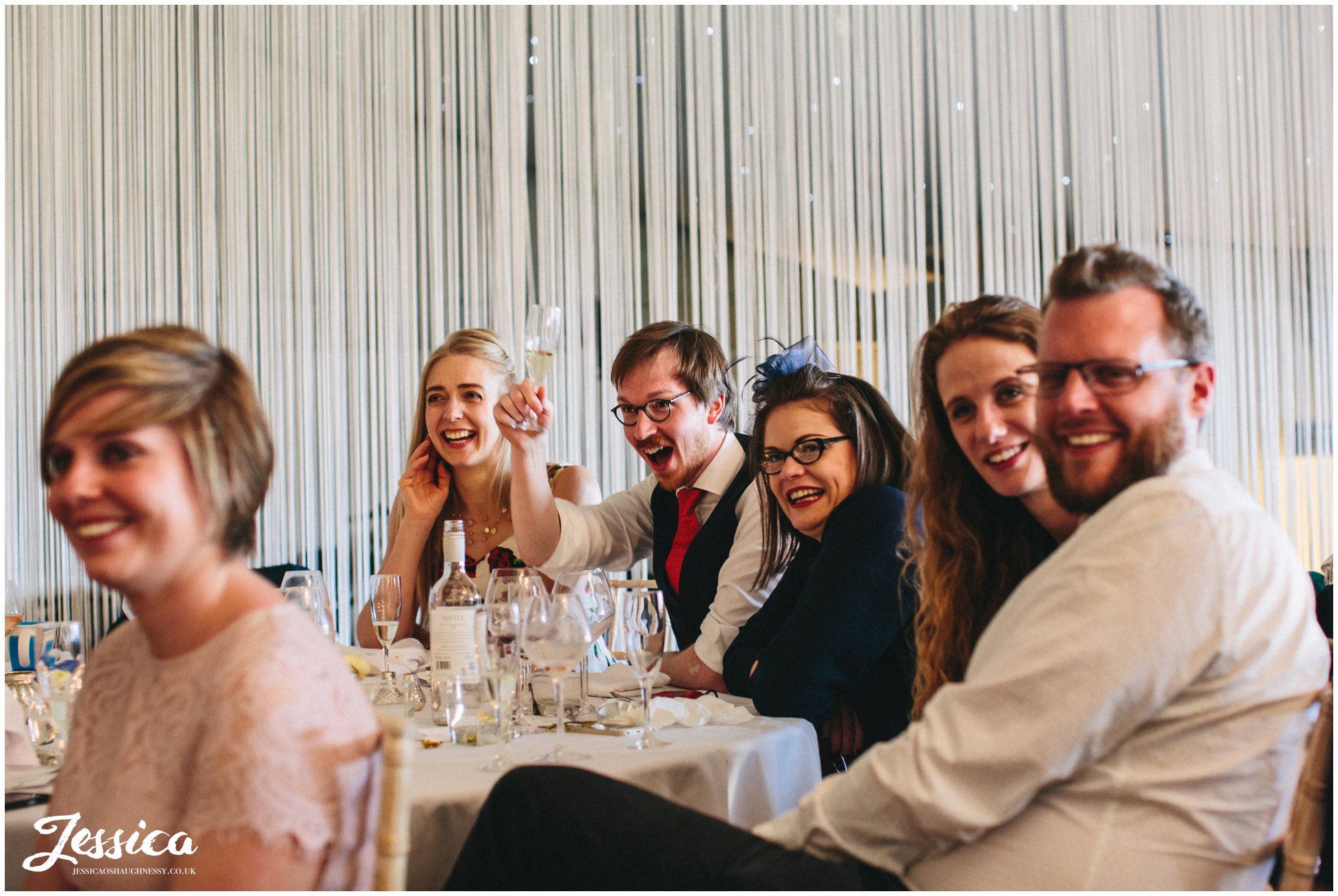 guests cheers during wedding speeches in whitchurch