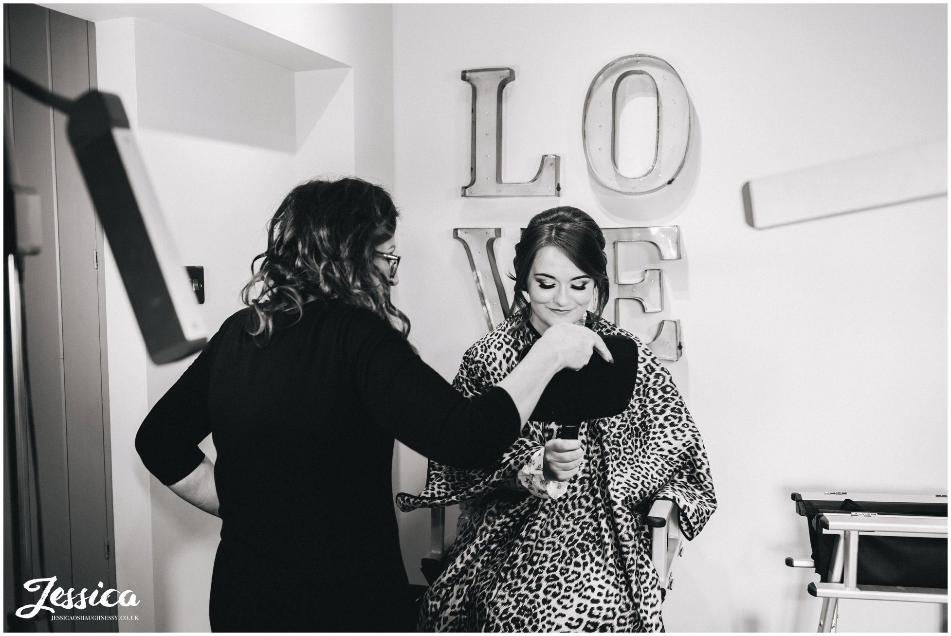 make up artist shows bride her finished makeup