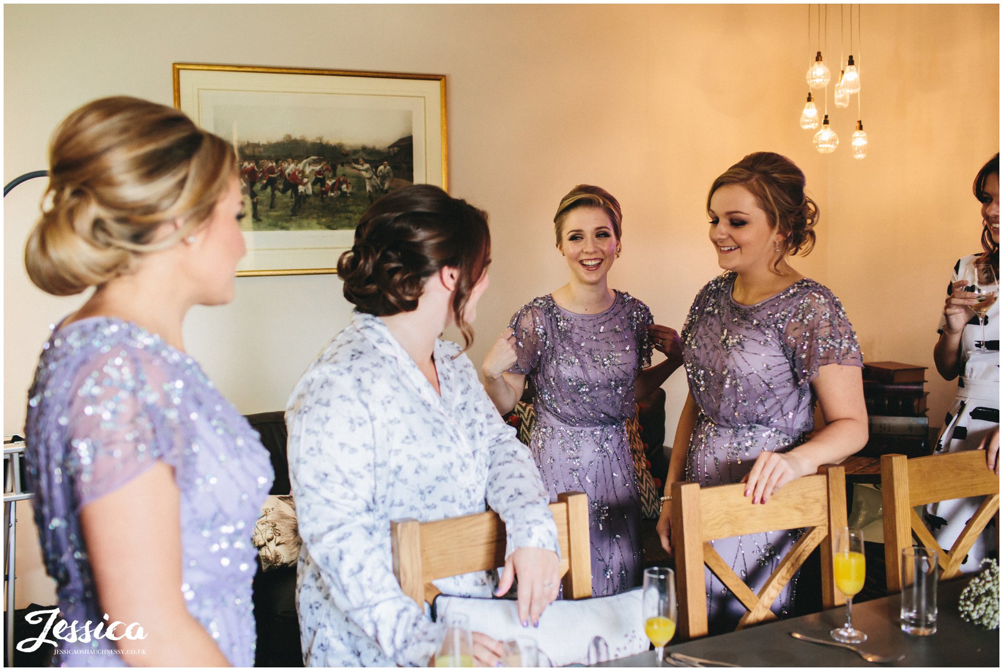 bridesmaids laugh with bride on her wedding morning in north wales