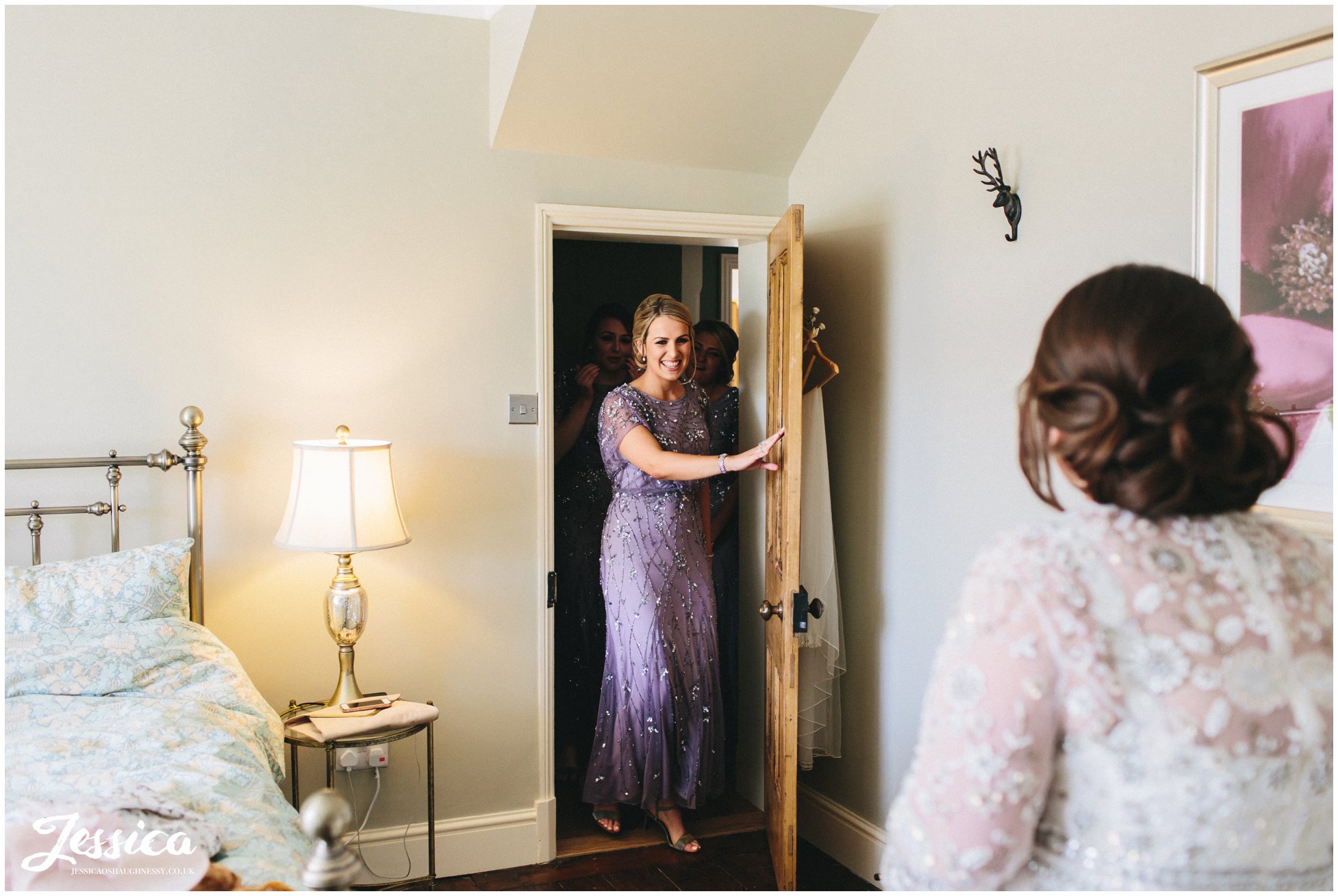 bridesmaids see the bride in her dress for the first time