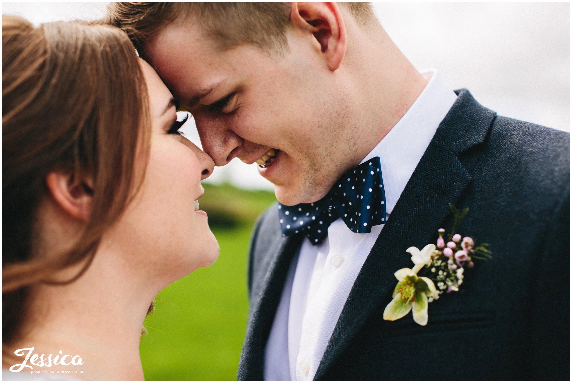 close up of groom smiling at his bride on their wedding day at tower hill barns