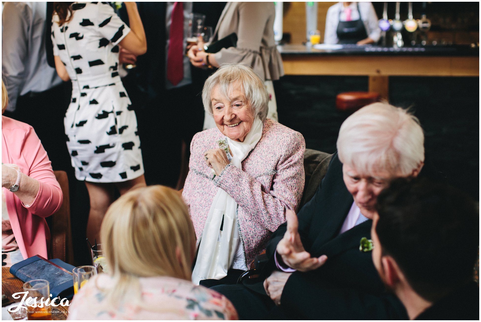 grandmother laughing at her granddaughters wedding
