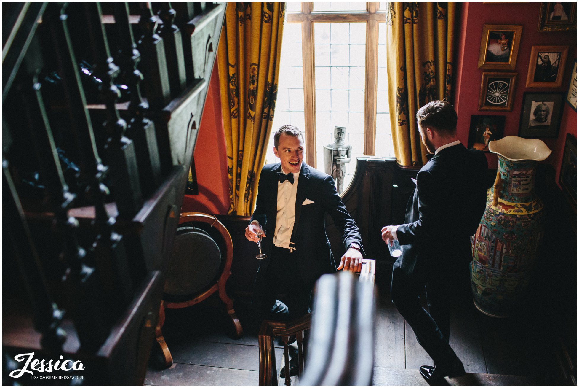 groom heads downstairs drinking champagne before the wedding ceremony