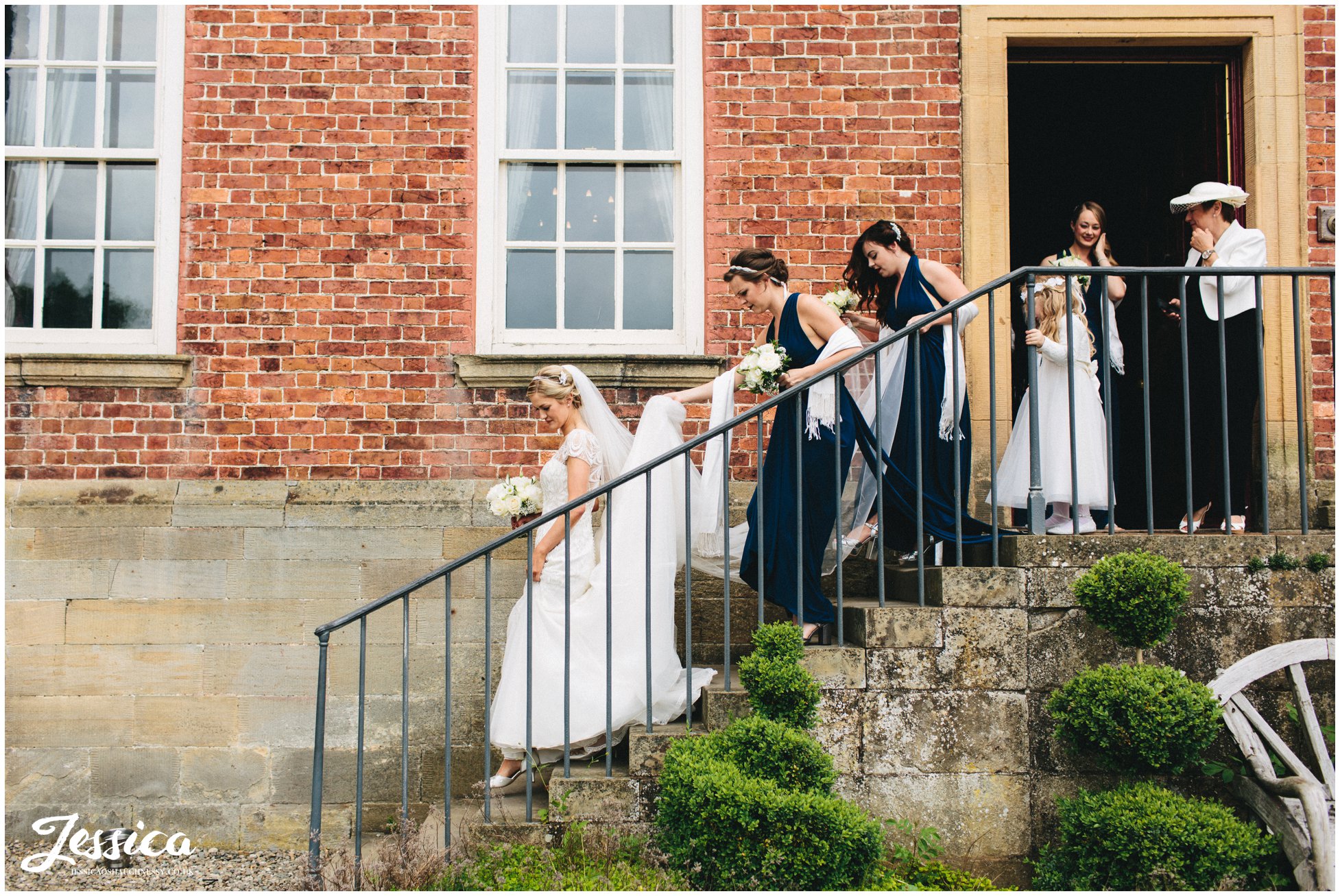 bridal party walk out of trevor hall to the ceremony