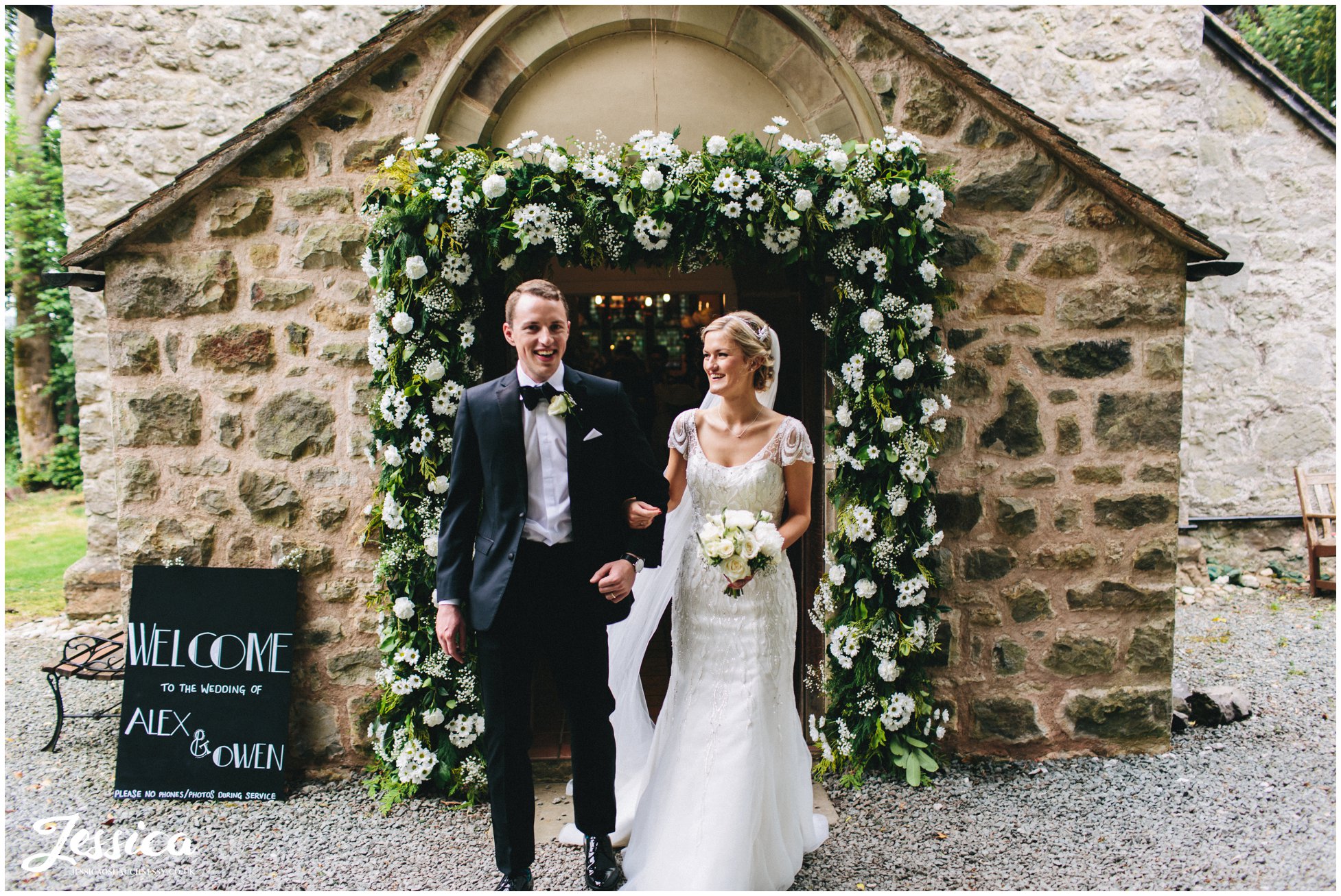 newly wed's exit Trevor Church under floral arch