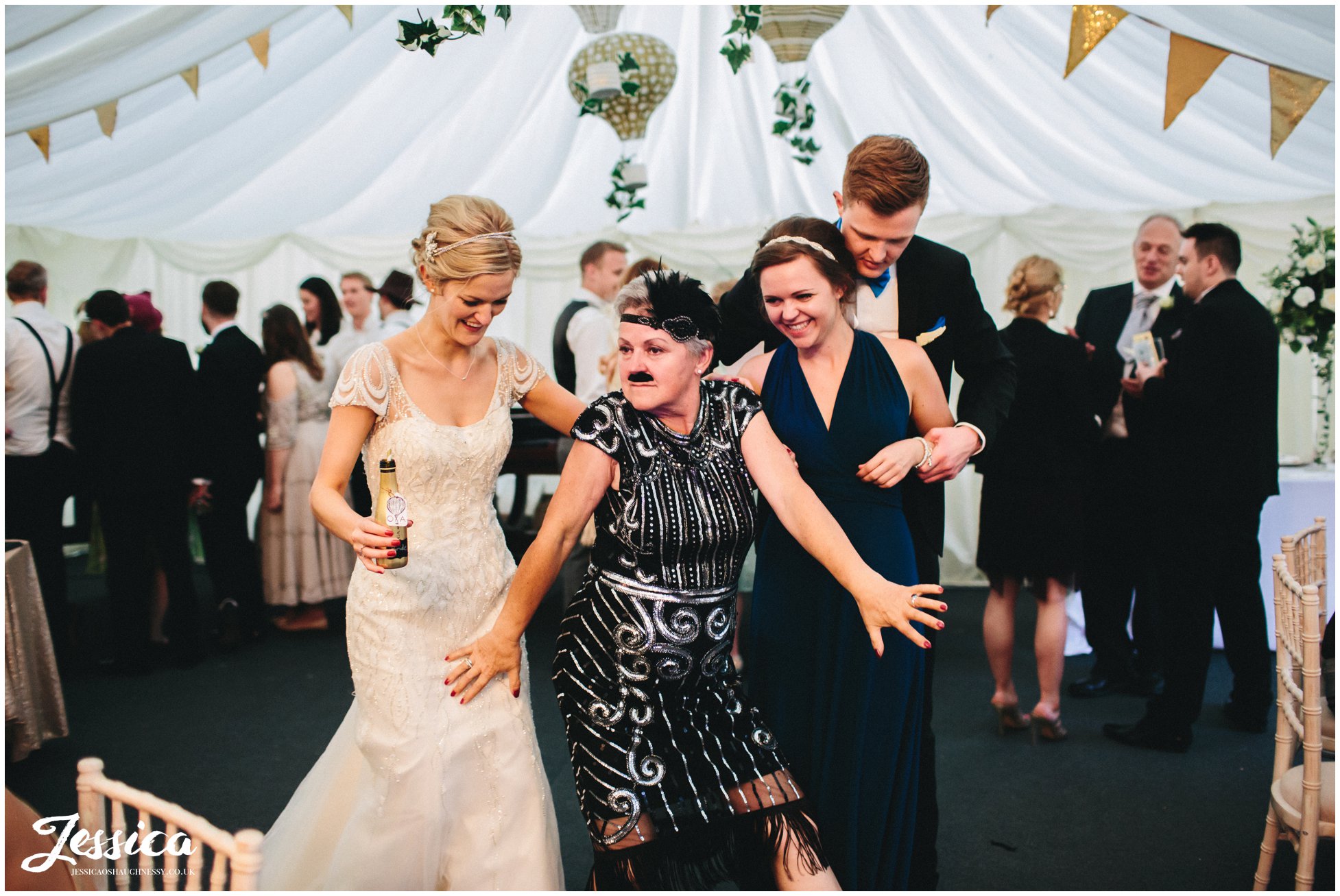 guest poses in 20's dress during a wedding in trevor hall