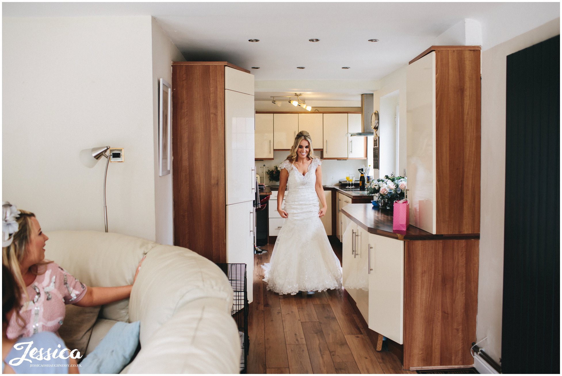 bride revealing her wedding dress to her family