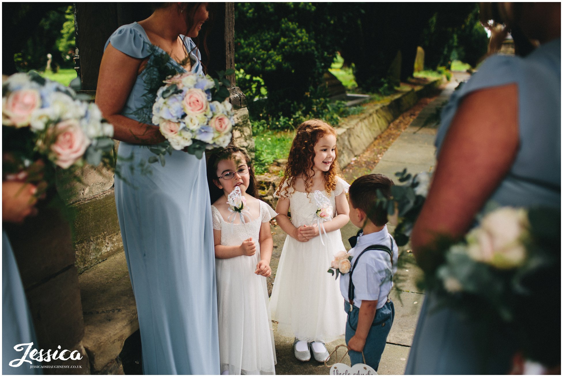 flower girls wait outside the church for the ceremony