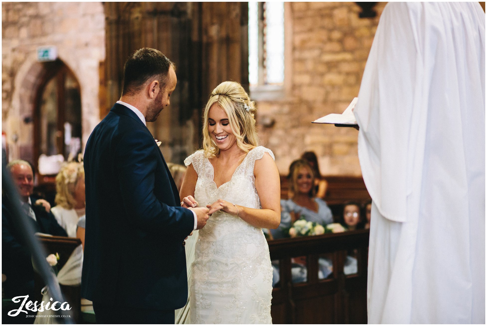 bride & groom exchange rings on their wirral wedding day