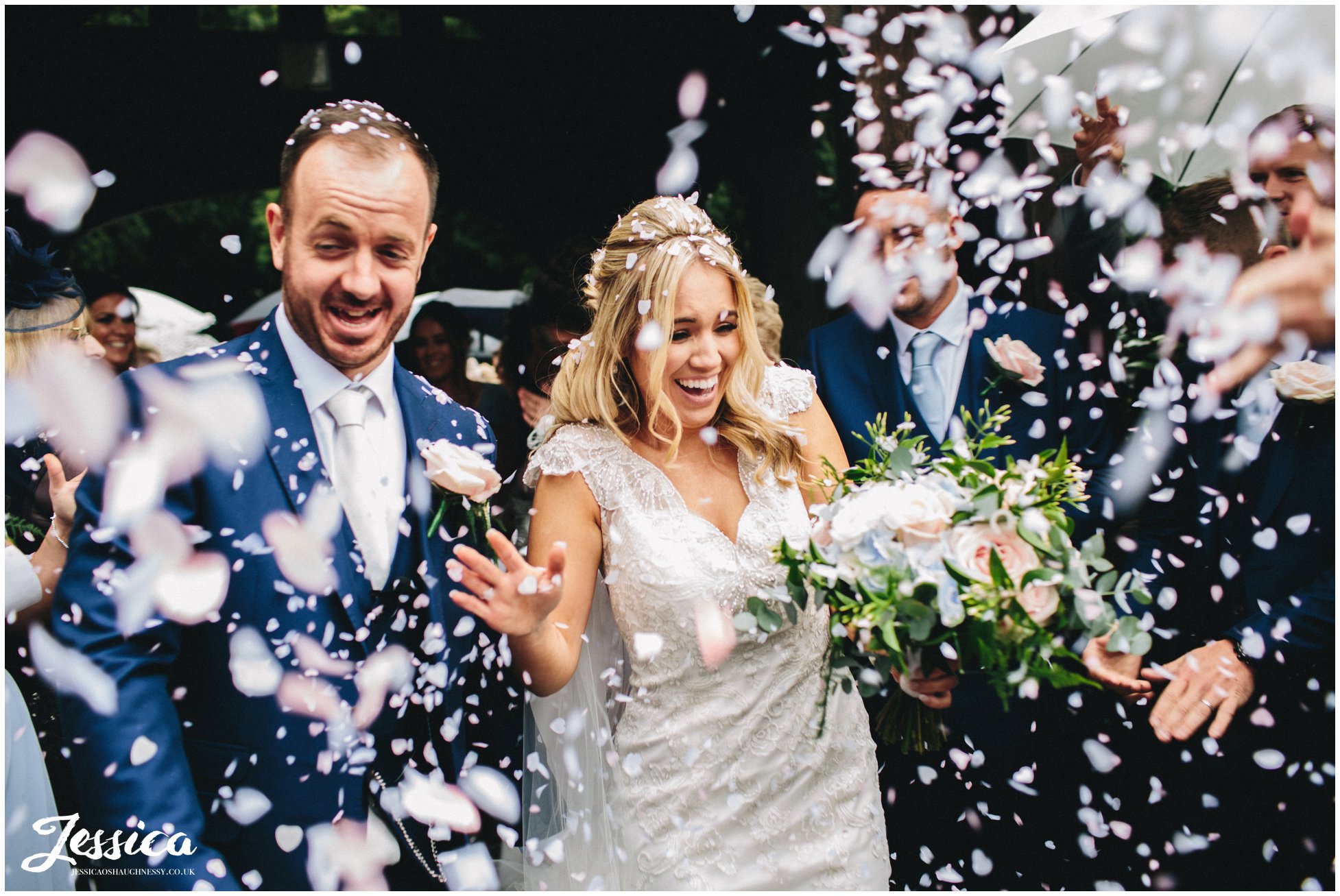 bride & groom walking through epic confetti line on their wirral wedding day