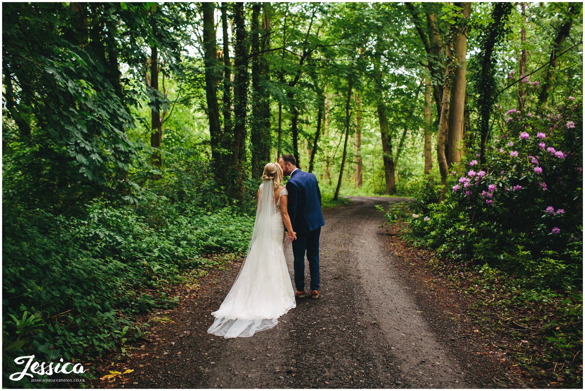 newly wed's kiss in the woodland by the lake side marquee, thornton manor