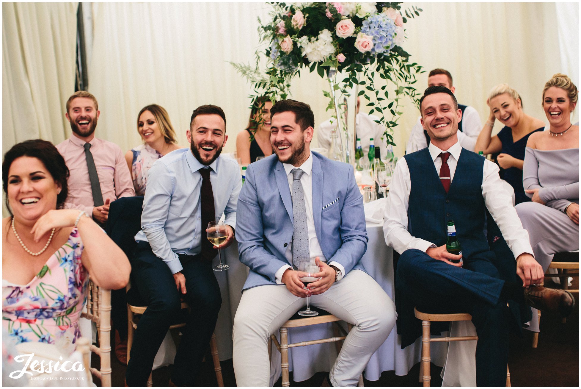 newly wed's friends laughing during the speeches