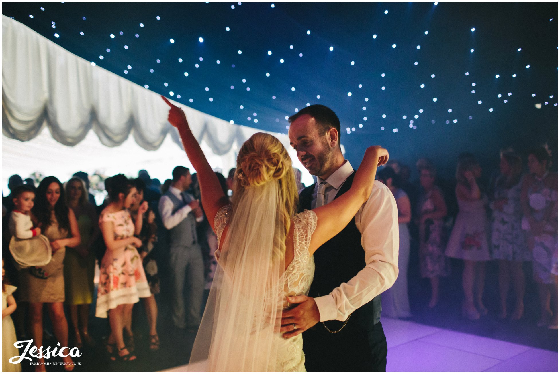 bride & groom share their first dance in the lakeside marquee - thornton manor