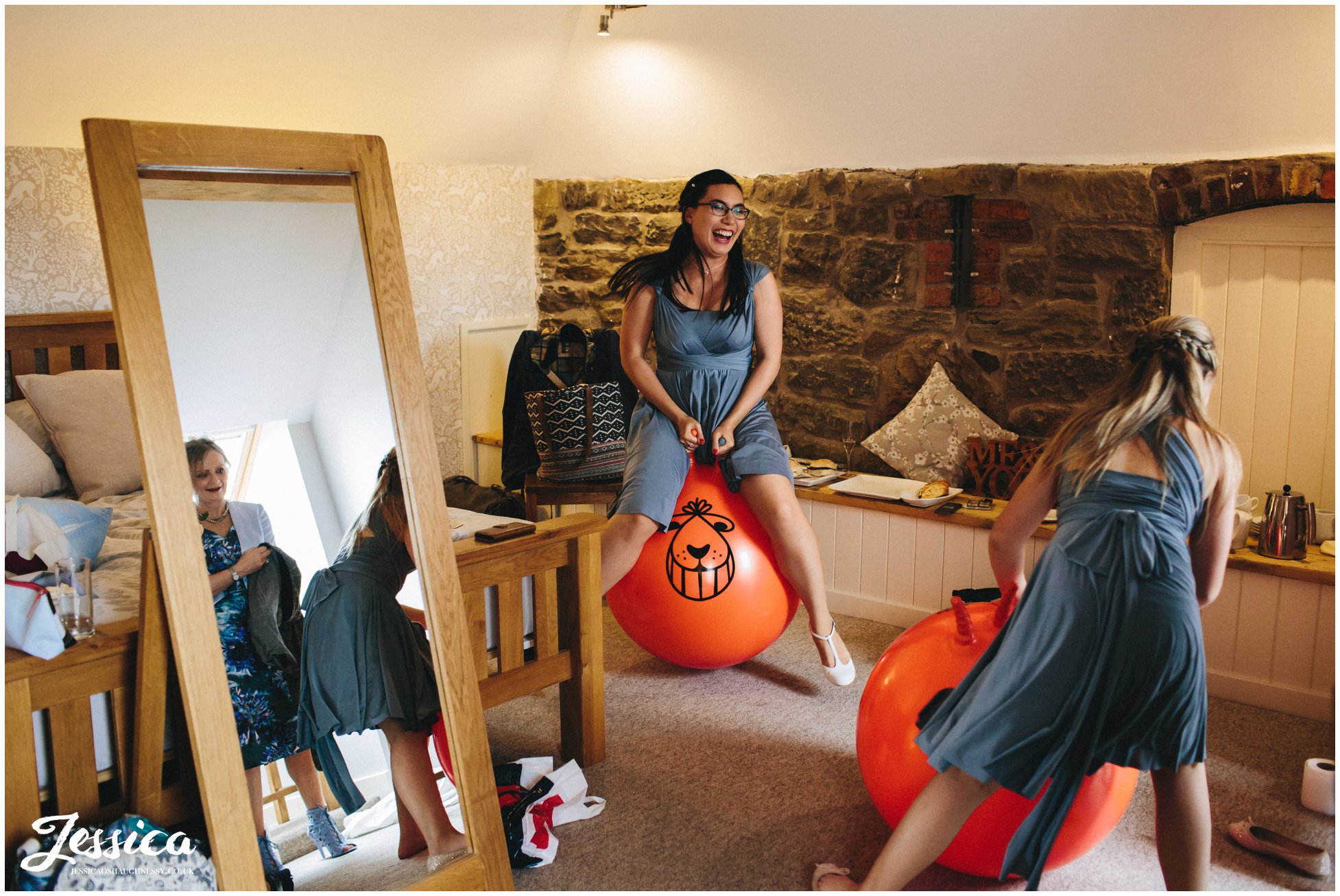 bridesmaids bounce on space hoppers in the tower hill barns bridal suite