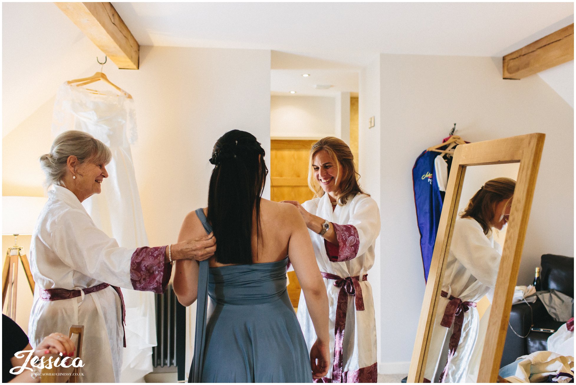 bridesmaid gets dressed ready for the tower hill barns wedding ceremony