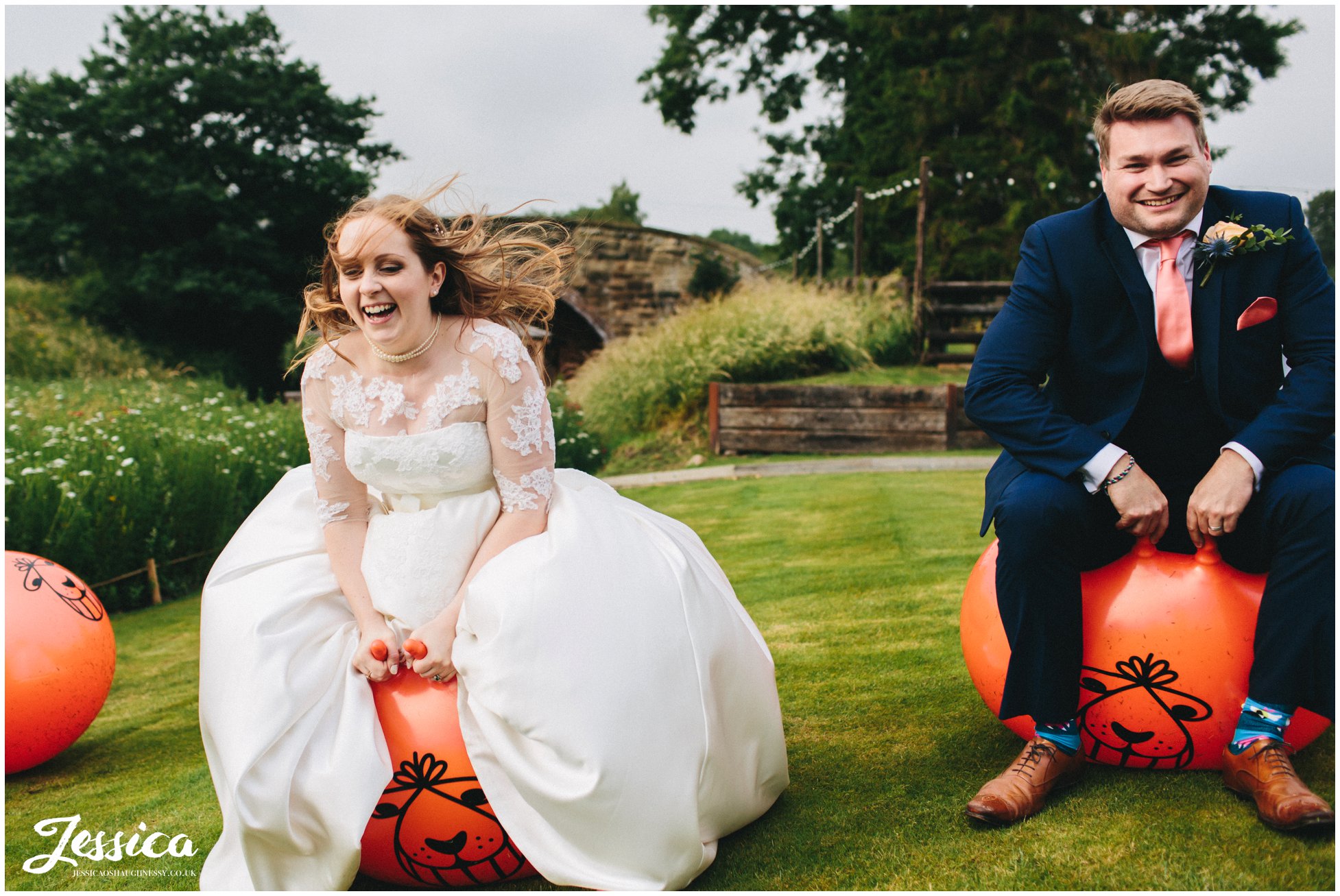 bride & groom bounce on space hoppers on their north wales wedding day