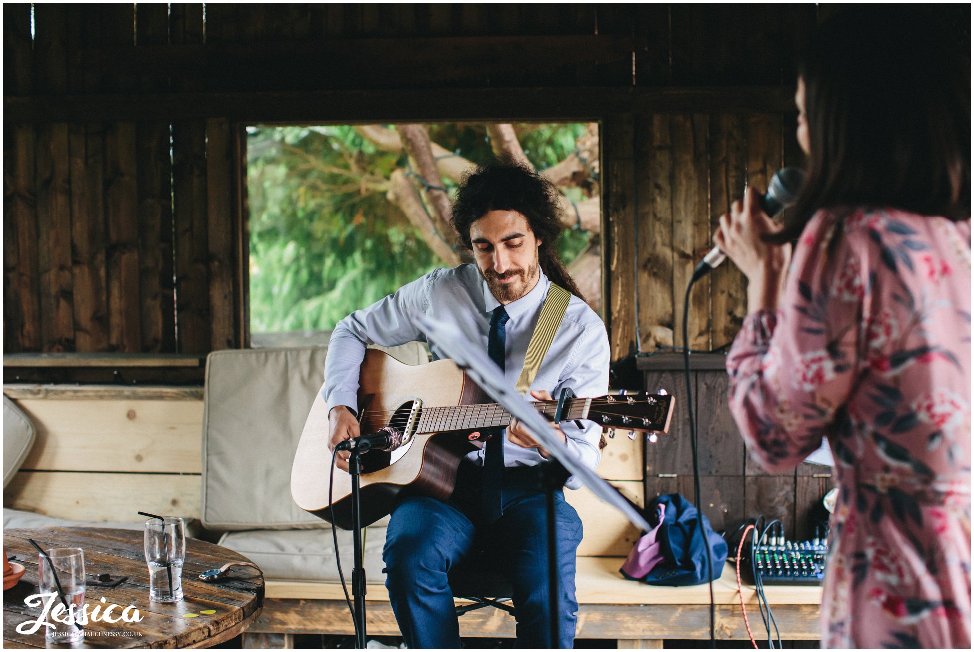 musicians play to the wedding guests in the smoking hut