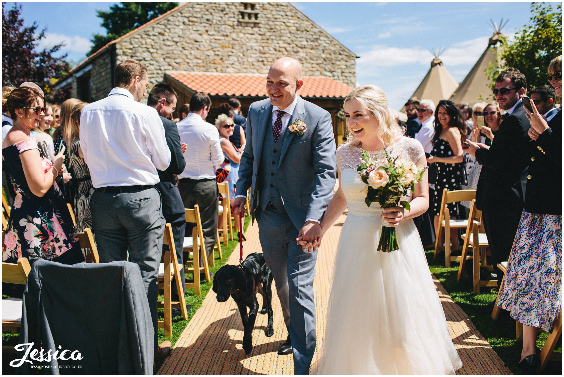 newly wed's walk down the aisle hand in hand after they're married