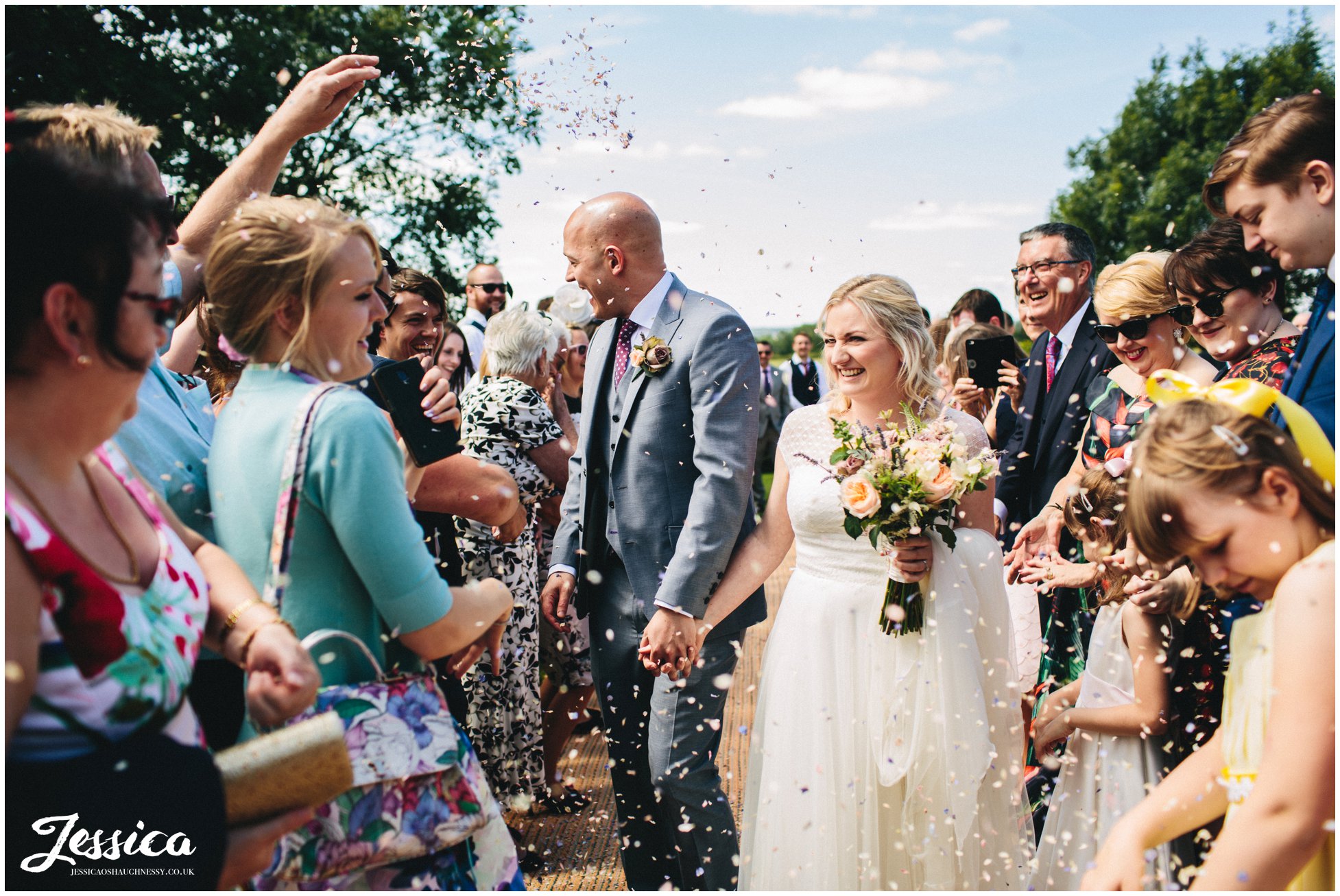 bride & groom walk through the confetti line