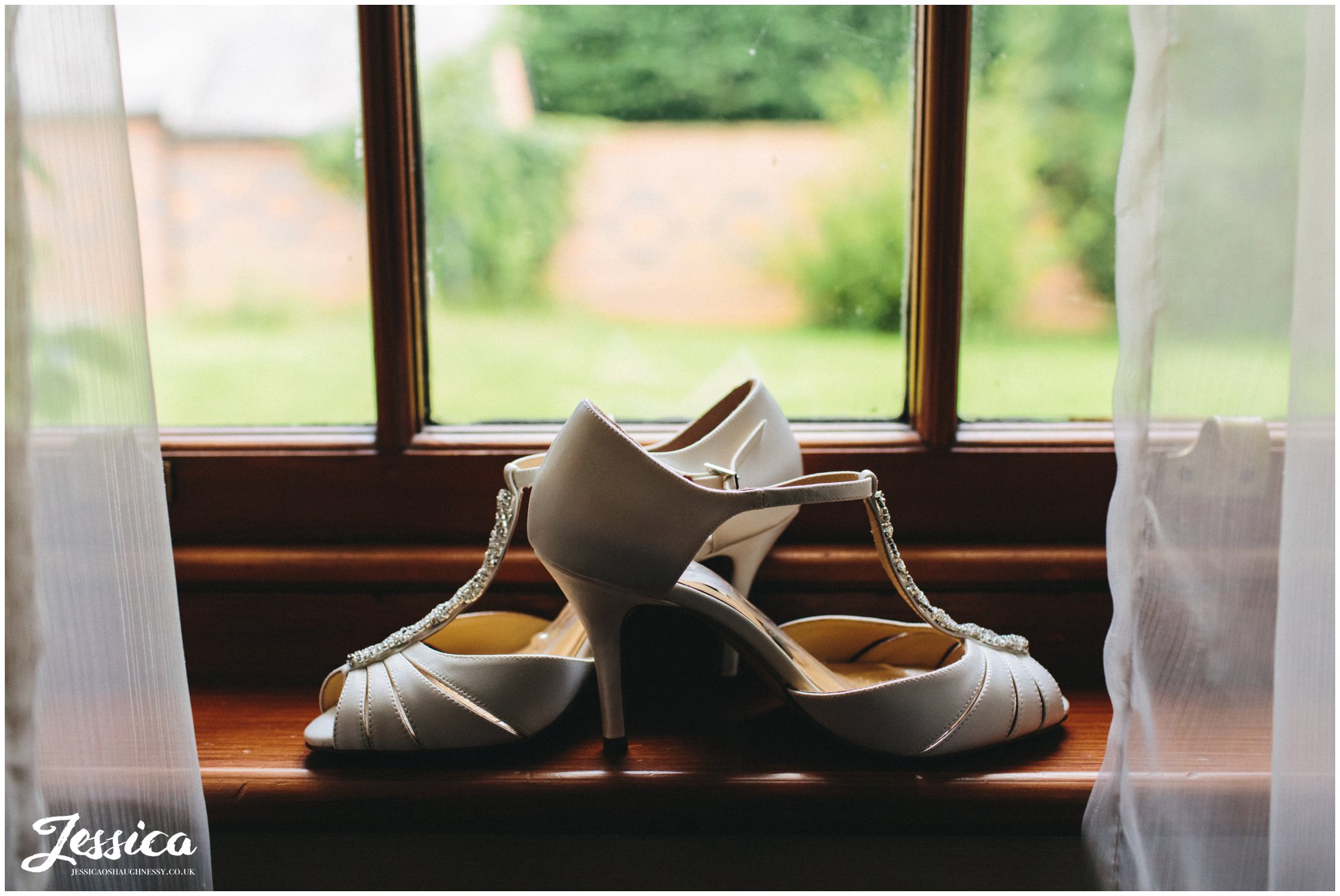 brides wedding shoes on windowsil