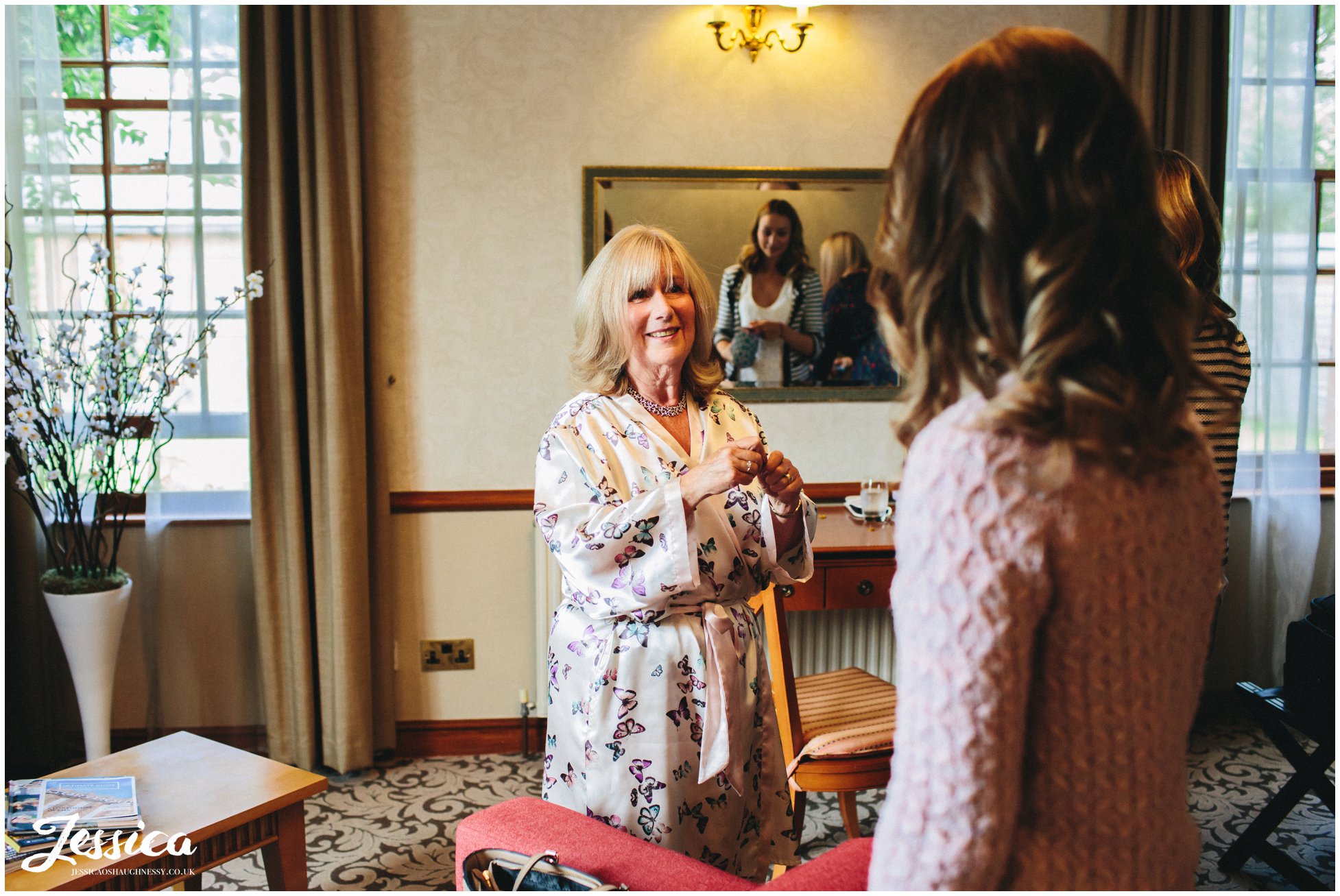 mother of the bride applying lipstick - nunsmere hall, cheshire