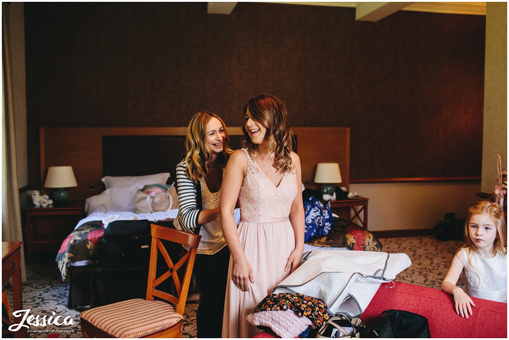bridesmaids getting into dresses for the wedding at nunsmere hall