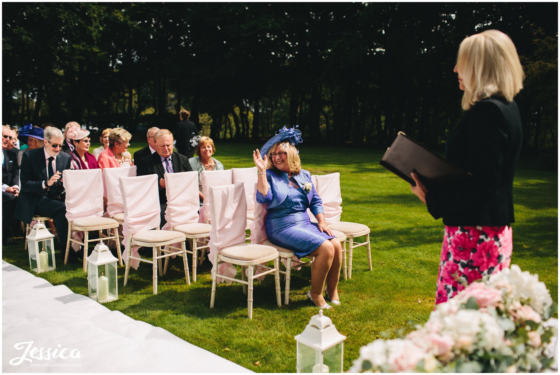 mother of the bride seated for outdoor wedding ceremony at nunsmere hall