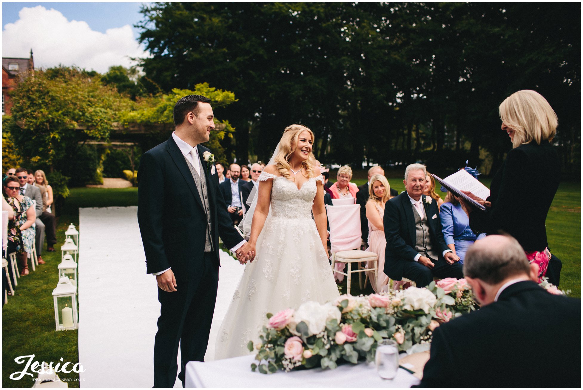 bride & groom hold hands during their cheshire wedding ceremony