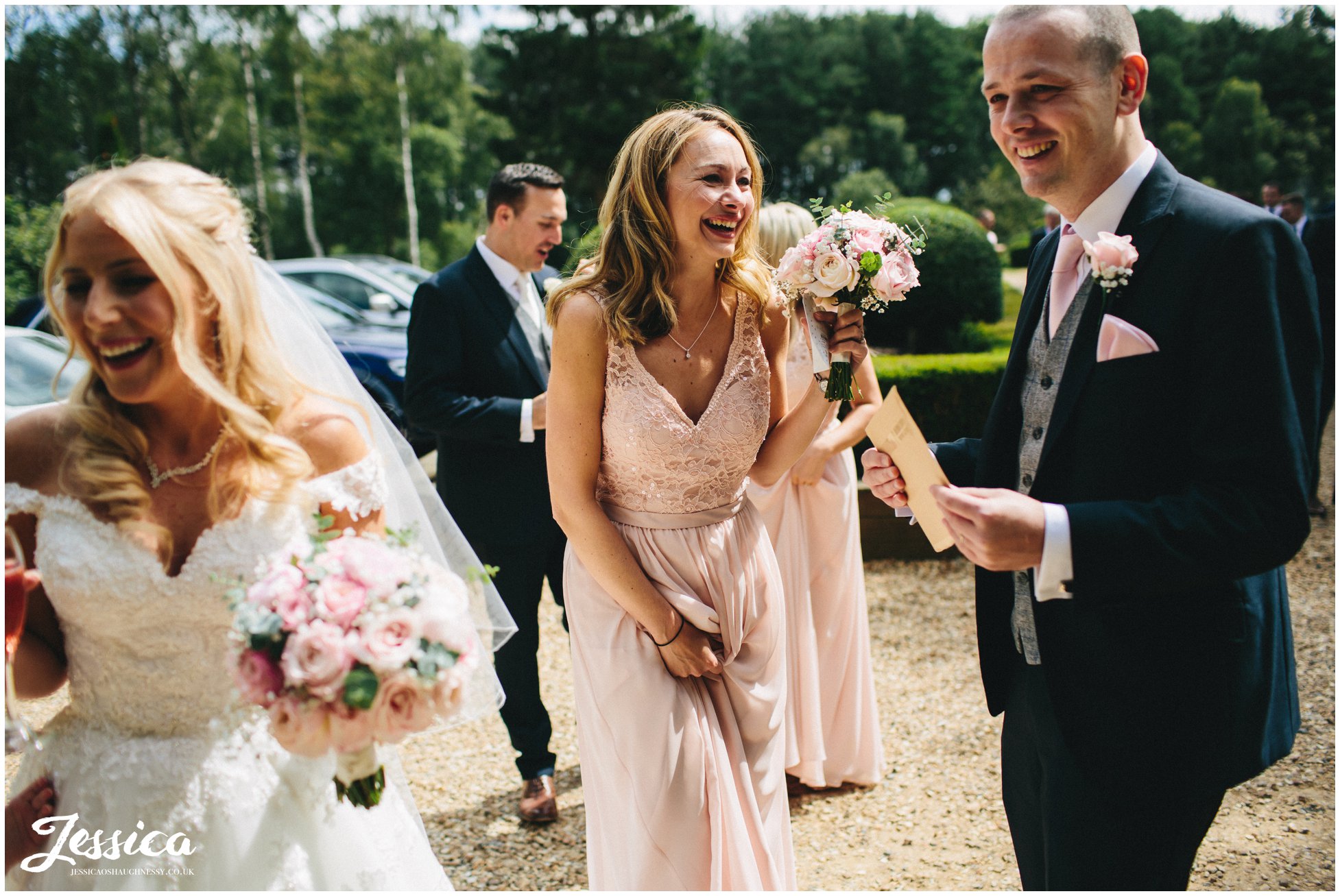 bridesmaid laughing after the nunsmere hall wedding ceremony in cheshire